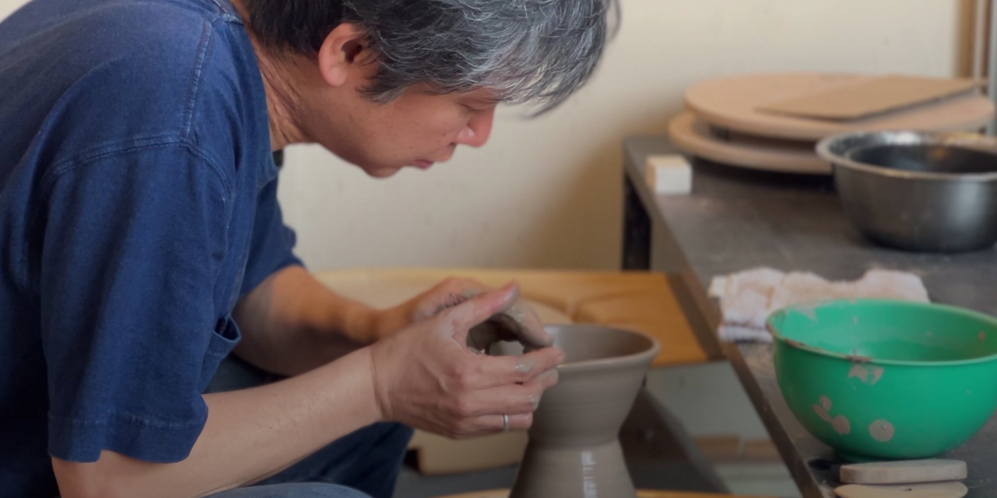 Master potter making japanese pottery. Tsukushi