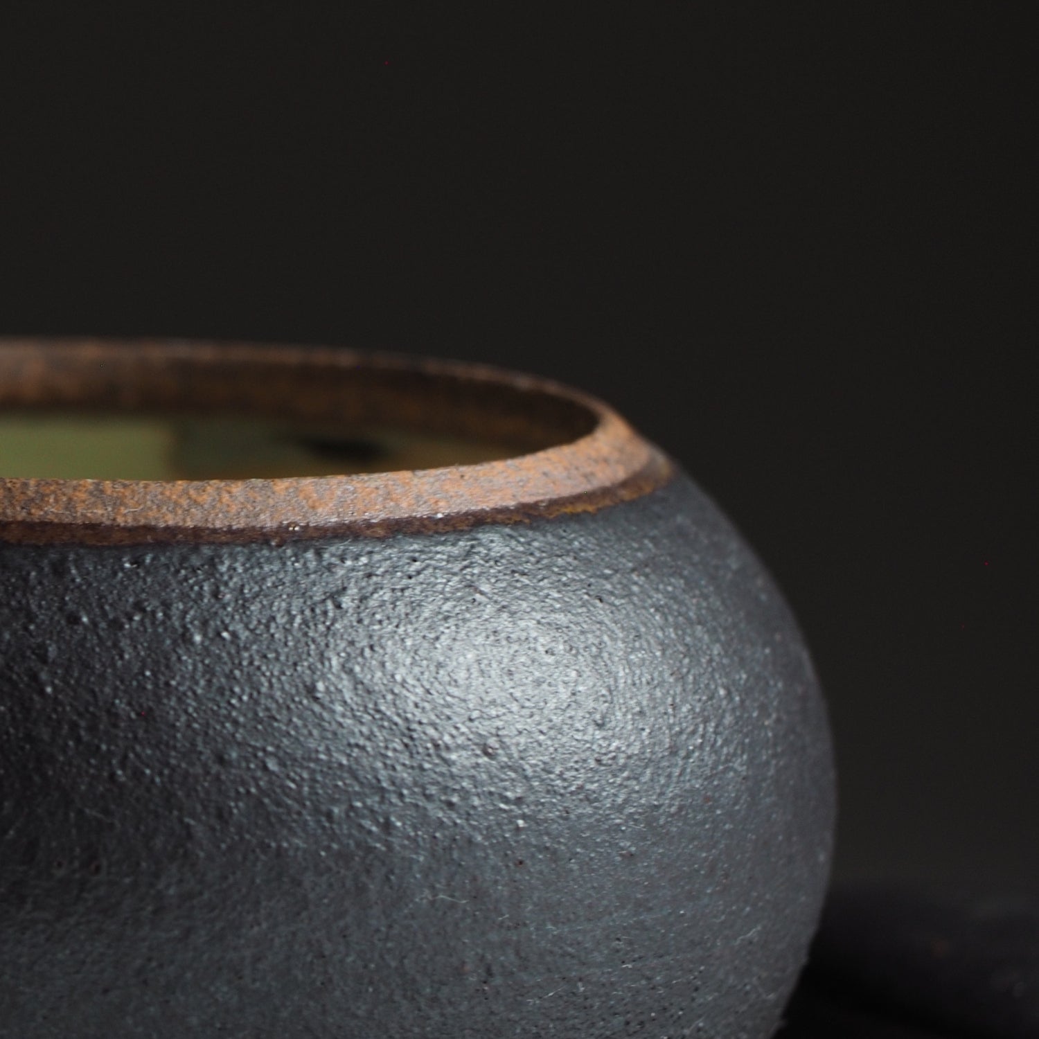 Japanese handcrafted black ceramic Chawanmushi bowl zoom black background, Tsukushi