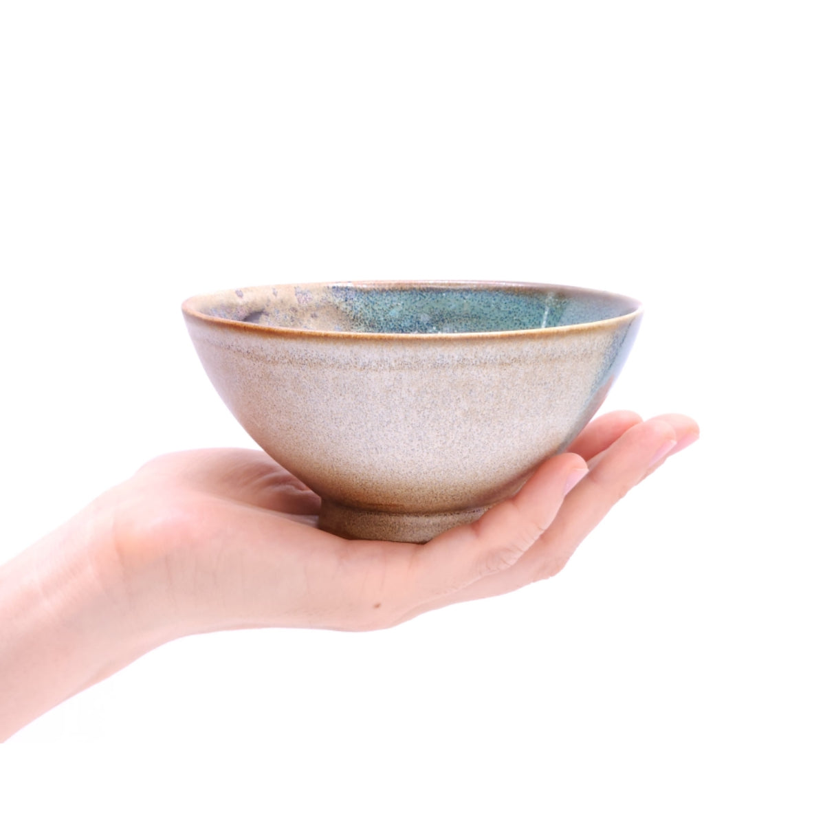 a woman hand holding a Japanese pottery bowl. Tsukushi