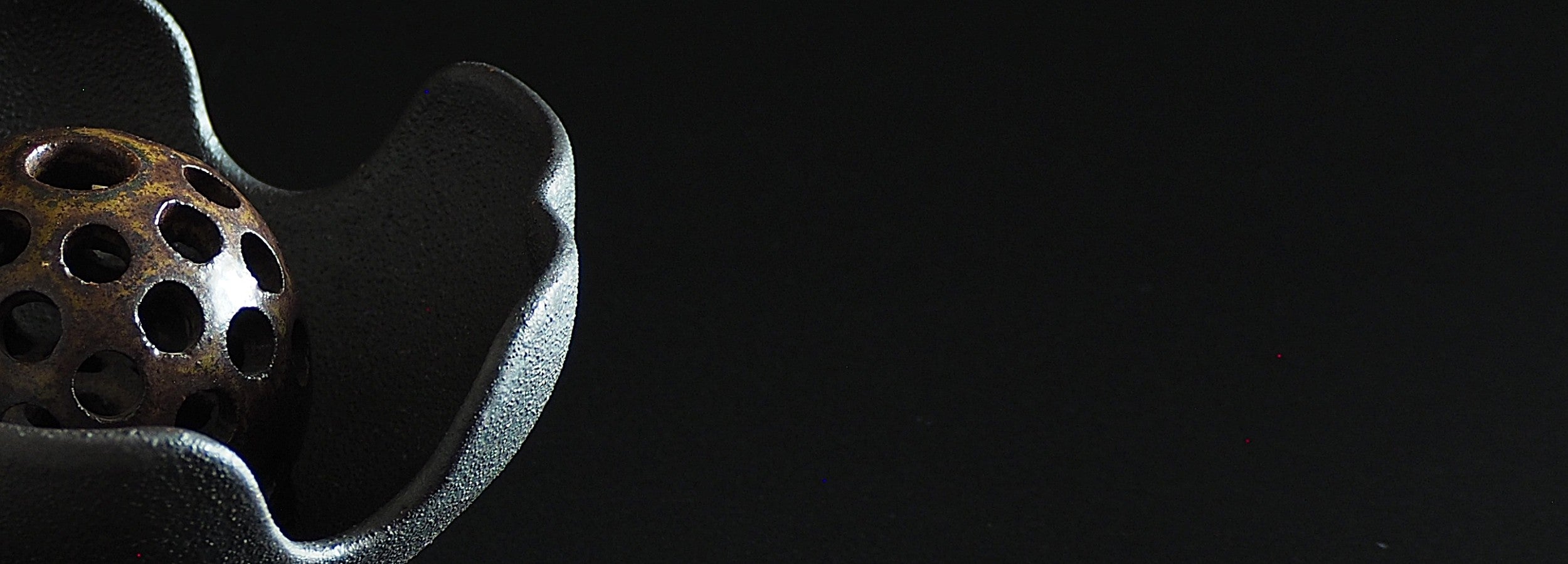 Japanese ikebana vase with ceramic flower frog an matching bowl on a black background. Tsukushi