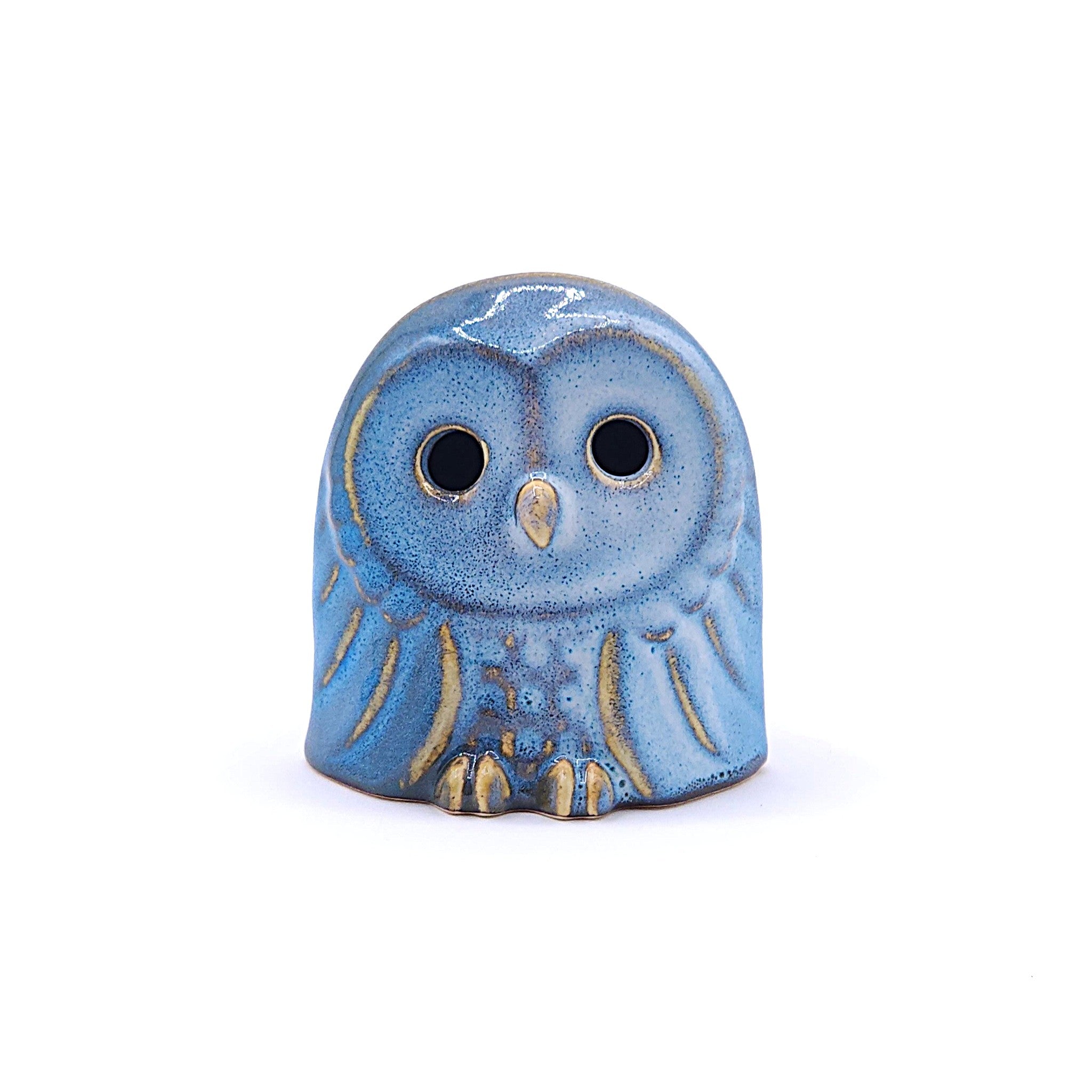 A handcrafted ceramic figurine of an owl with a blue. Tsukushi