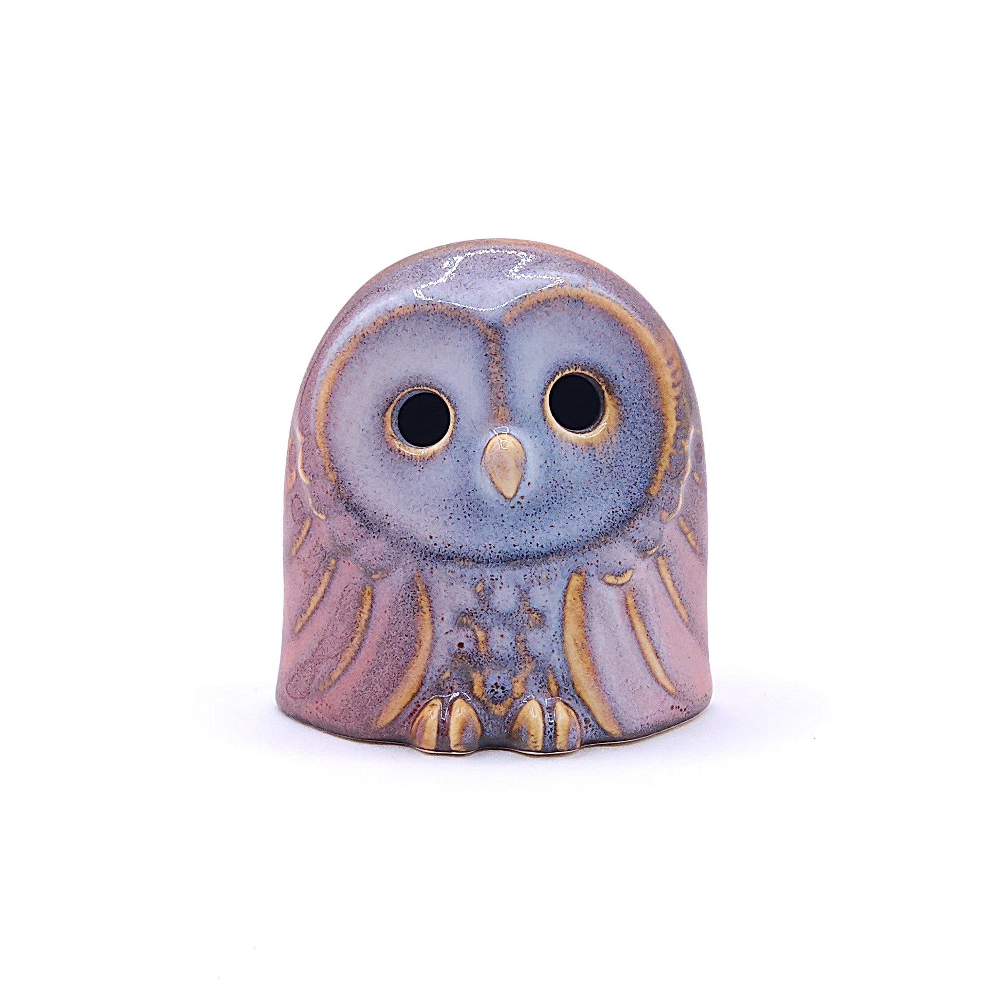 A handcrafted ceramic figurine of an owl with a pink. Tsukushi