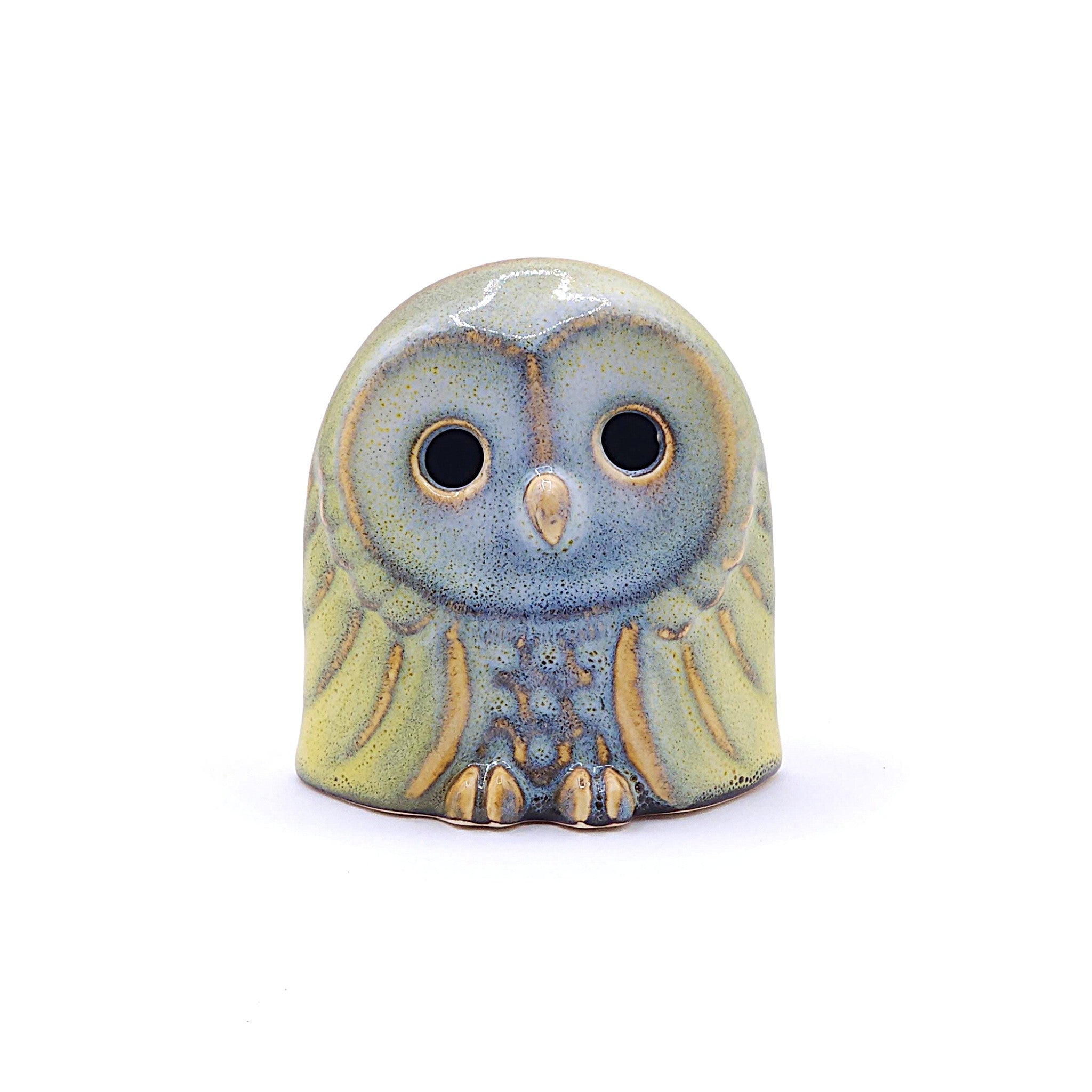 A handcrafted ceramic figurine of an owl with a yellow. Tsukushi