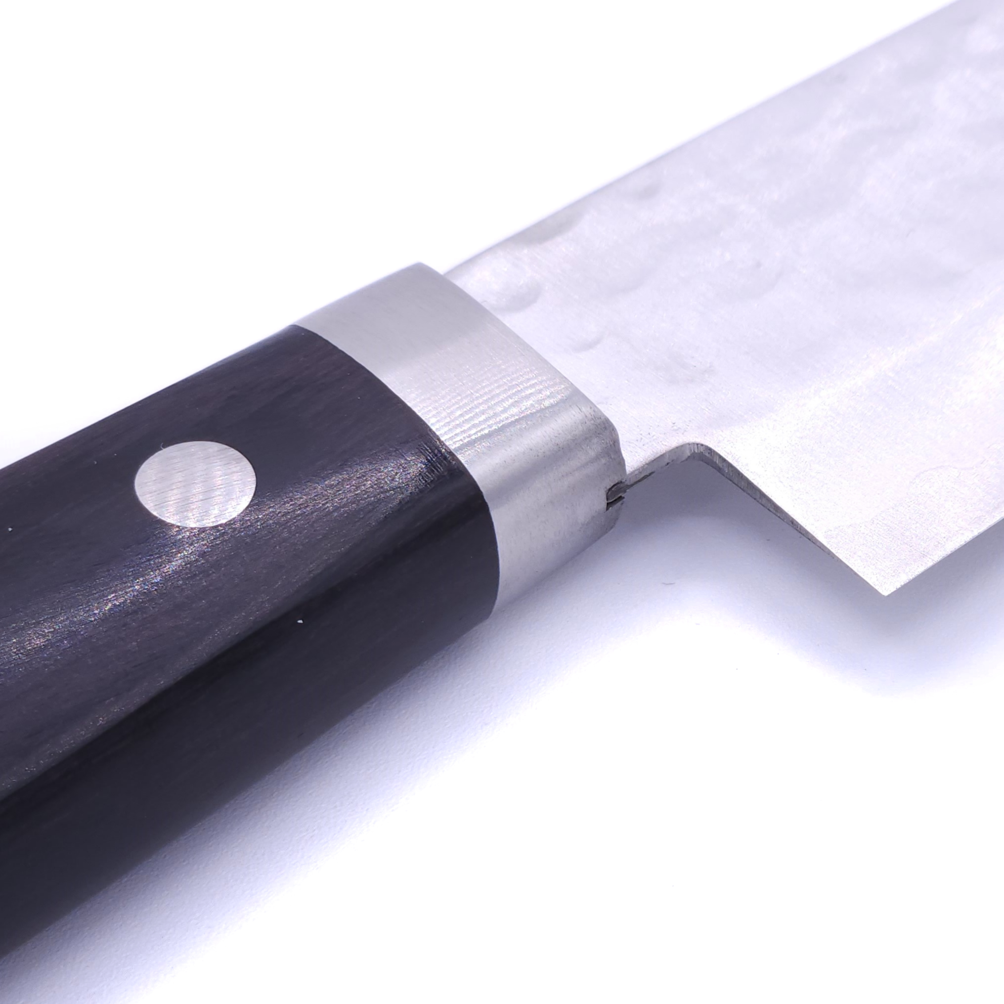 Bolster of a Japanese Santoku knife with black handle Crafted in VG1 by Minamoto Mitsukane cutlery, 140mm.
