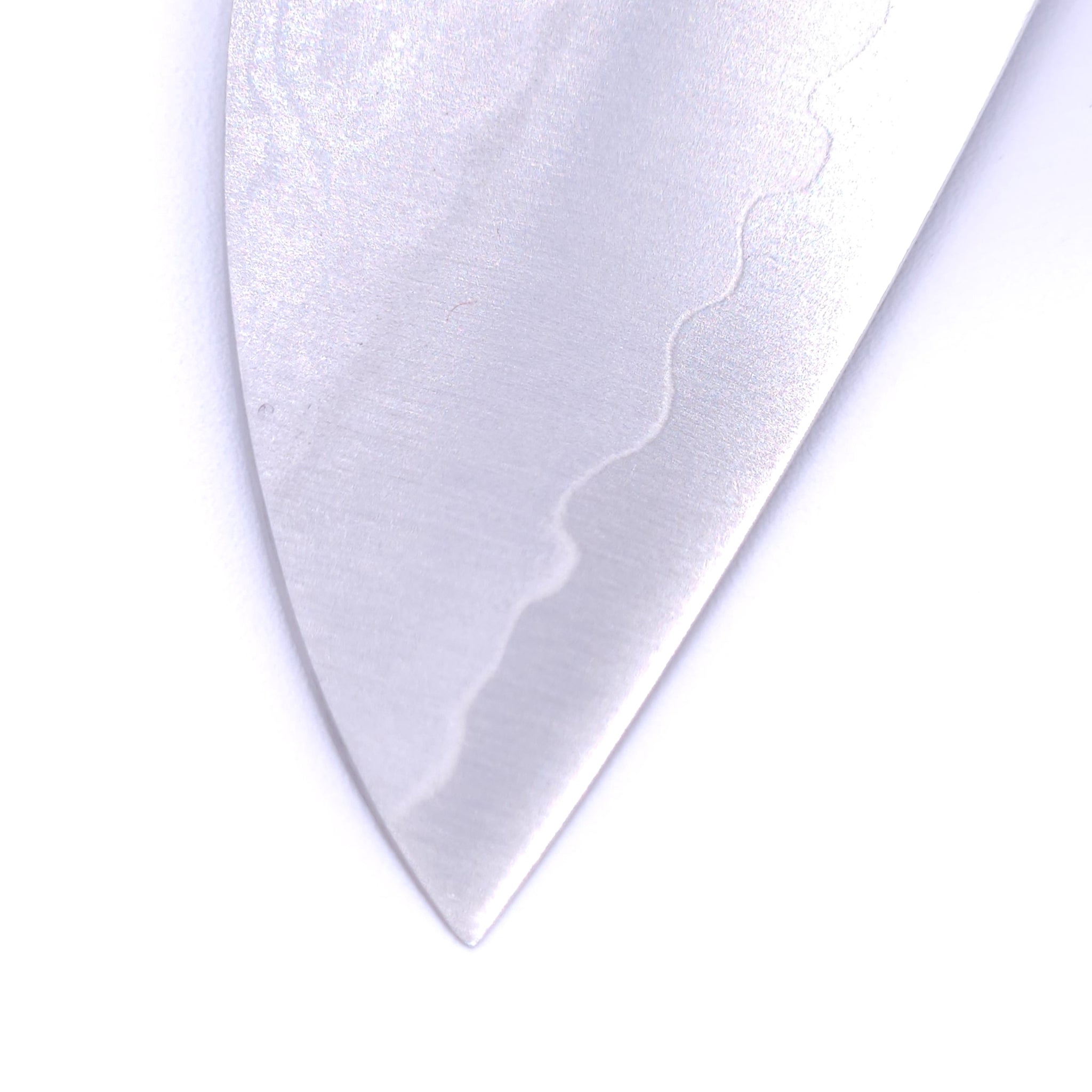 point of a Japanese Santoku knife with black handle Crafted in VG1 by Minamoto Mitsukane cutlery, 140mm.