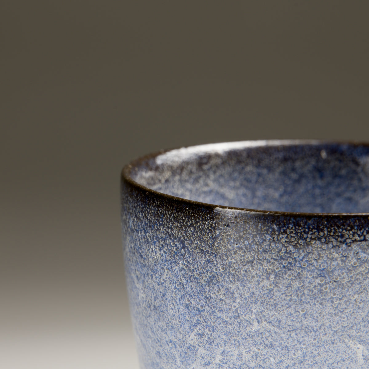 Close-up of Seigen ochoko sake cup showing the blue kannyū crackle glaze
