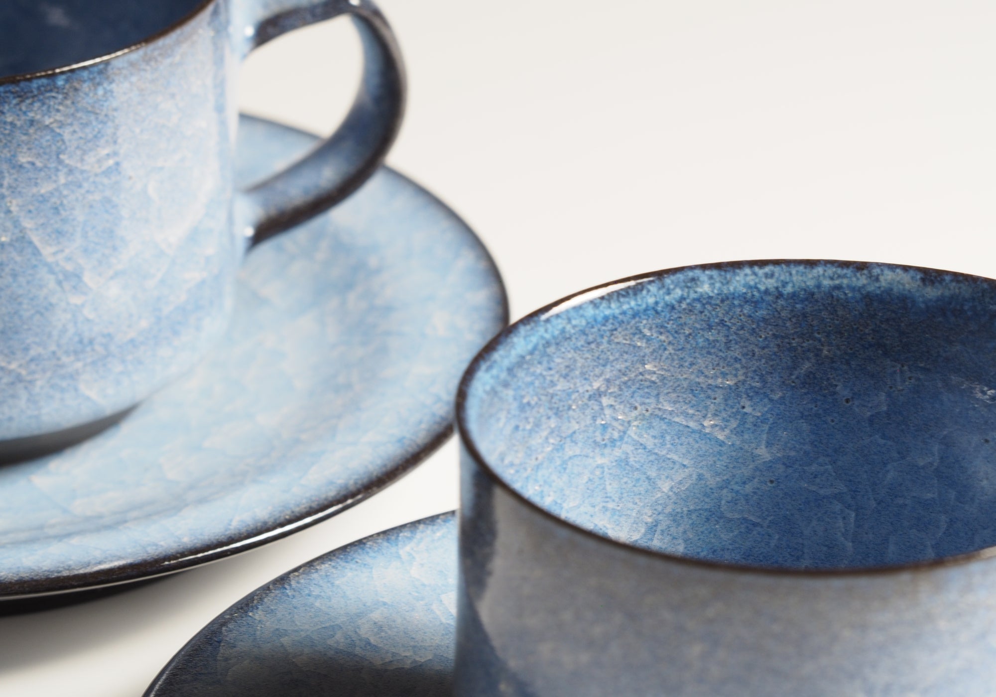 Handcrafted crazing Japanese ceramic coffee cups and saucers white background zoom, Tsukushi