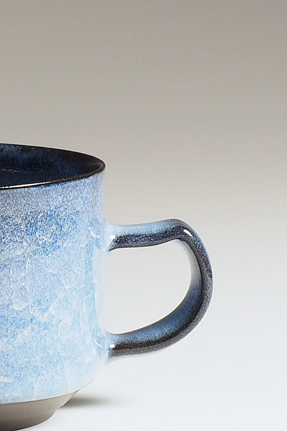 Handcrafted crazing Japanese ceramic coffee cup beige background zoom, Tsukushi