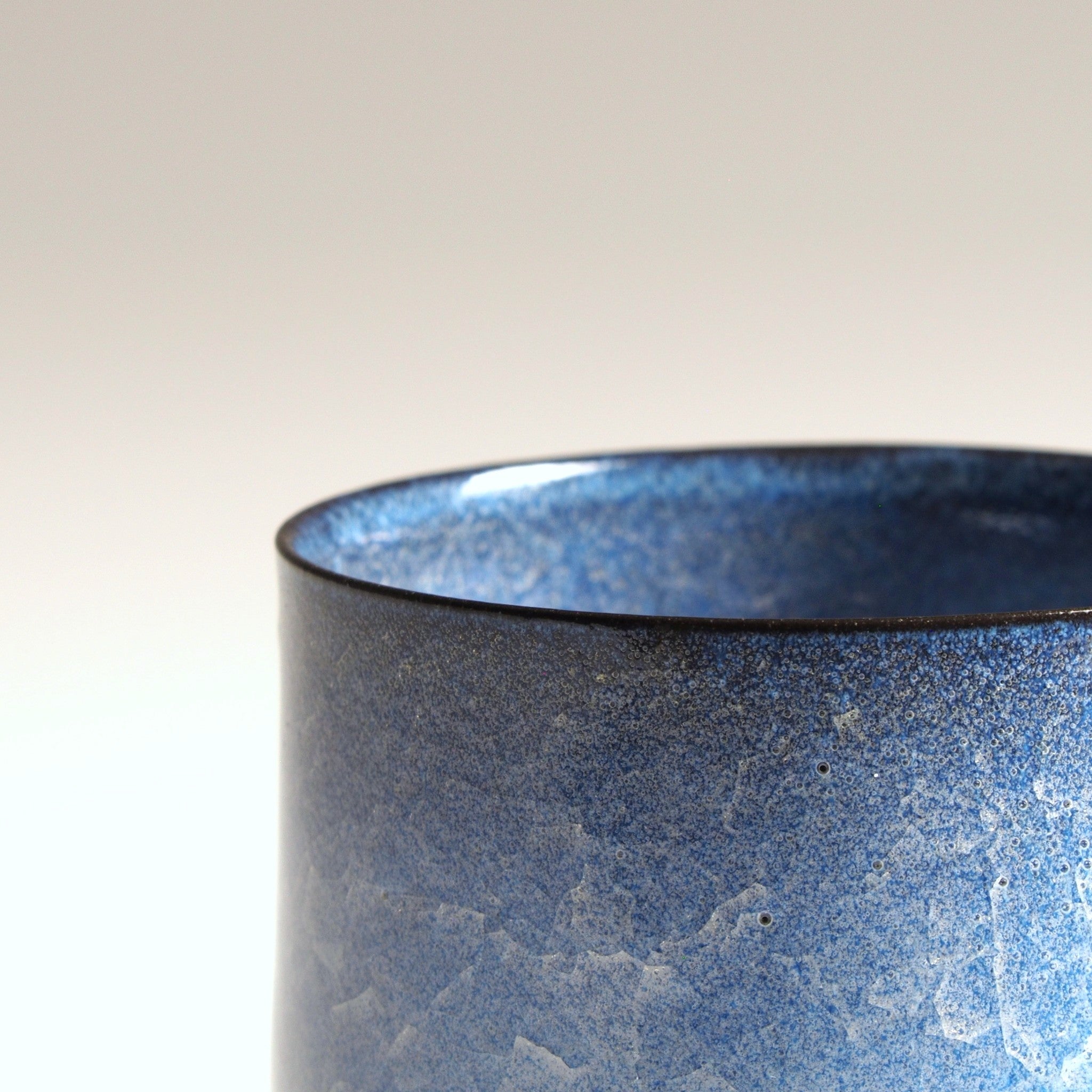 Handcrafted crazing Japanese ceramic coffee cup beige background zoom, Tsukushi