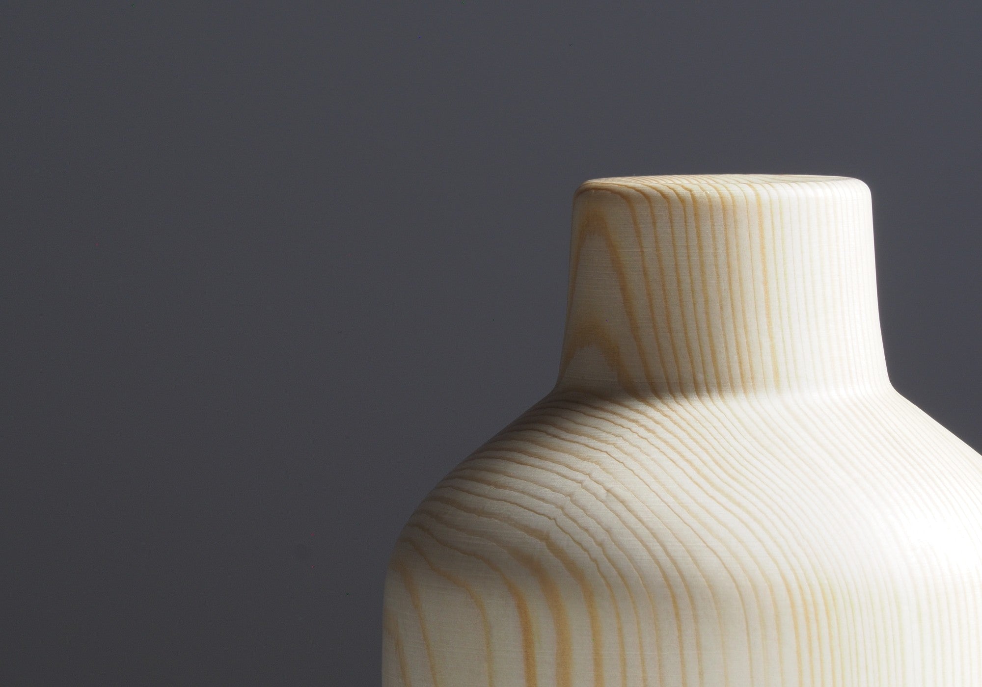 Detail of Japanese wooden vase called Shinon on a dark beige background. Tsukushi
