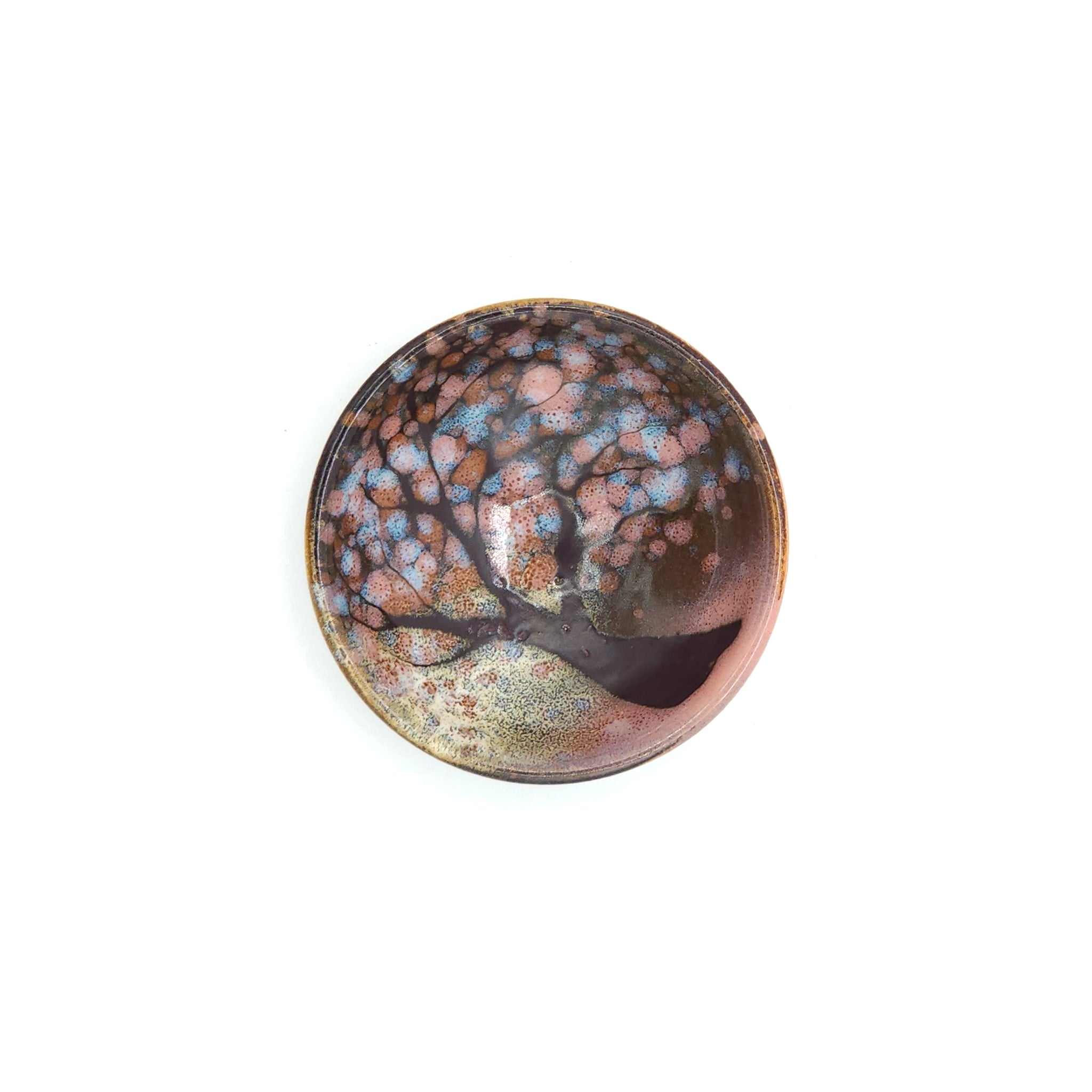A top view of a Japanese ceramic flat Sake cups with a cherry blossom pattern. Tsukushi