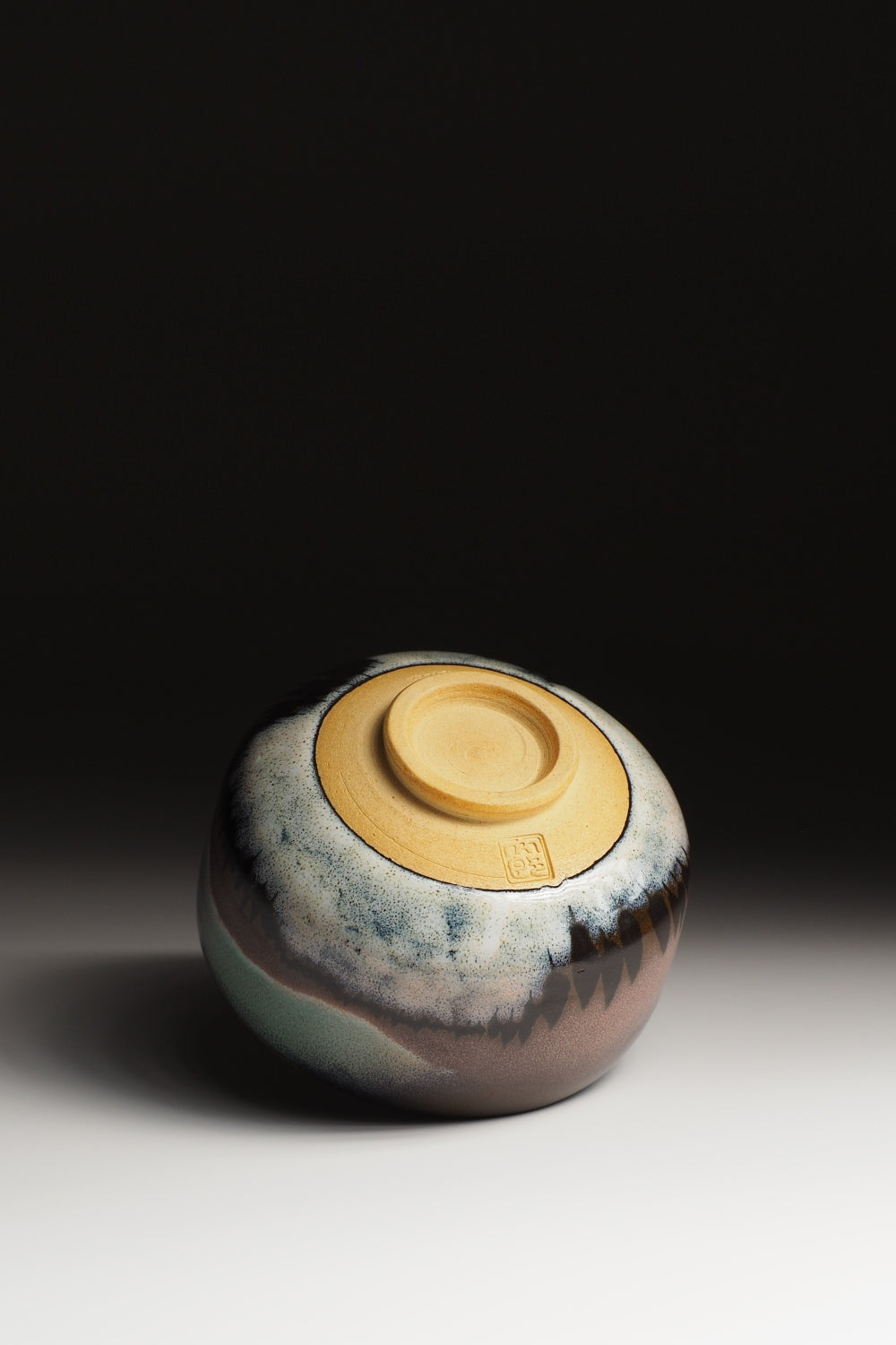 A bottom view of a Matcha bowl on a gradient background. Tsukushi