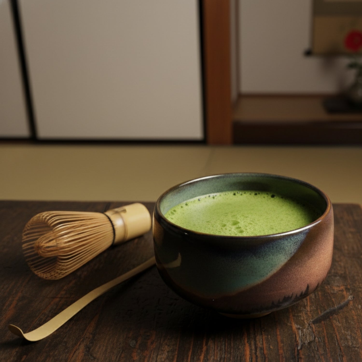 Ceramic Matcha bowl with green tea and bamboo whisk on a wooden surface | Tsukushi