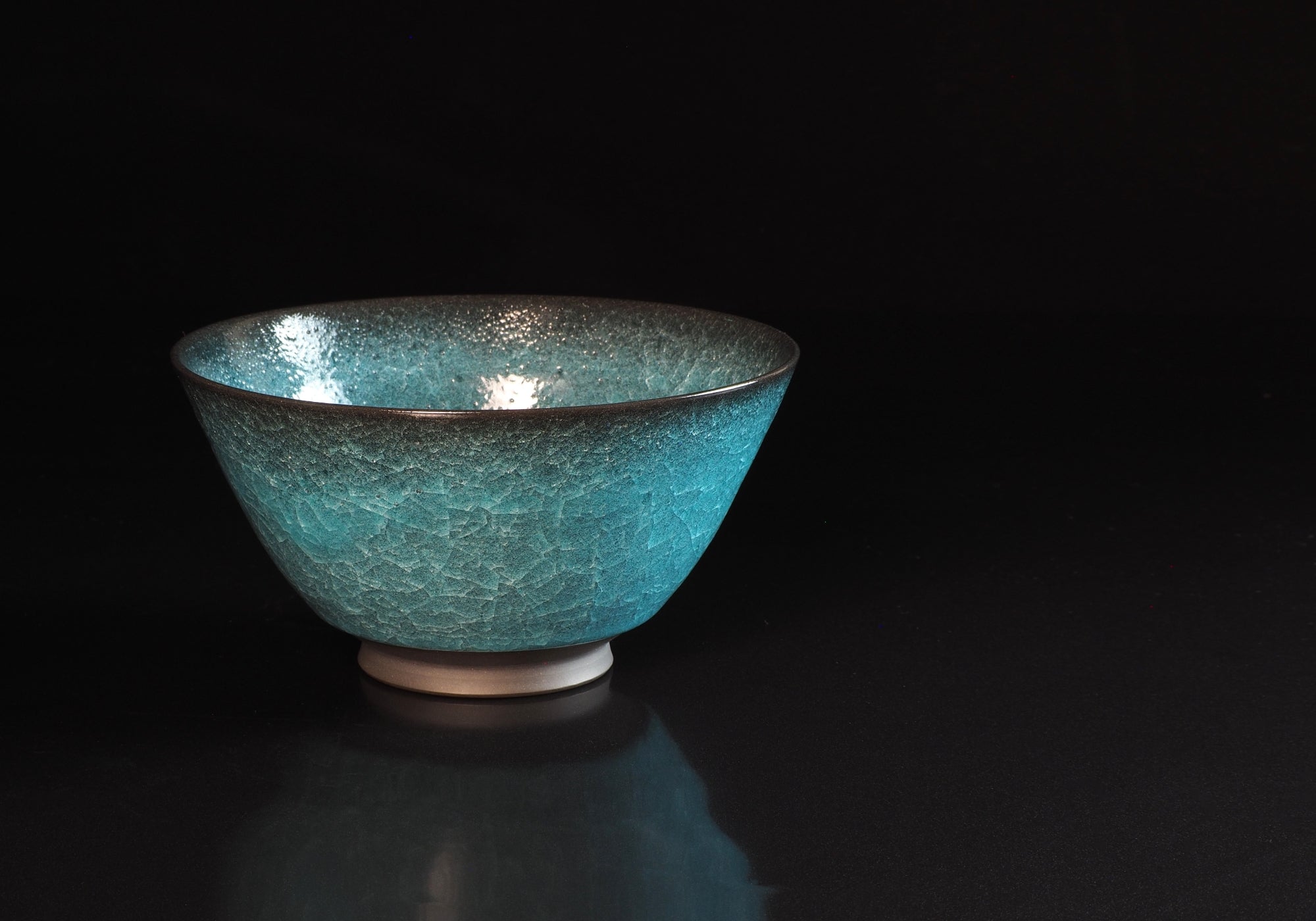 Japanese ramen bowl bowl on a black mirrored background. Front view