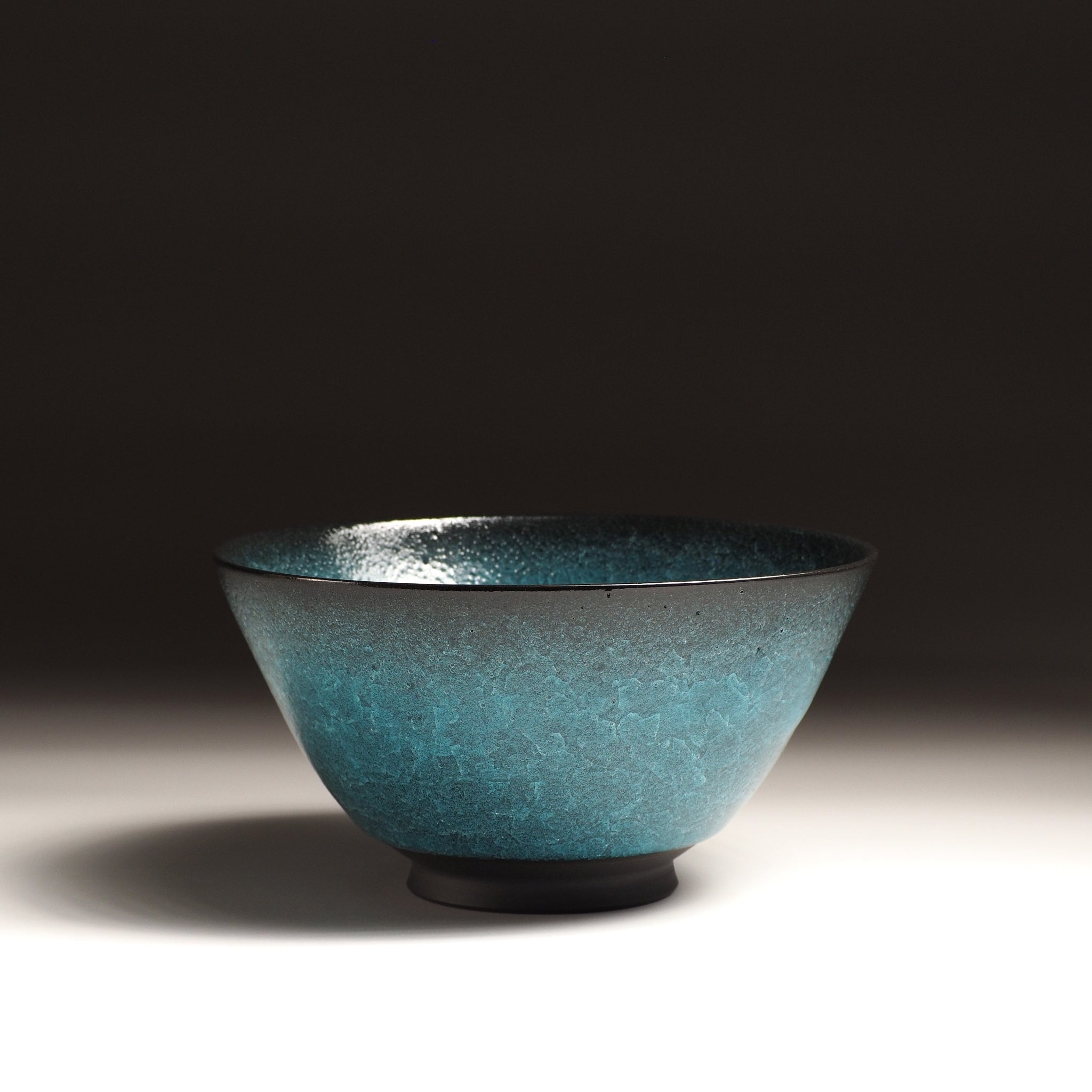 Japanese Emerald green ramen bowl bowl on a dark background. Front view