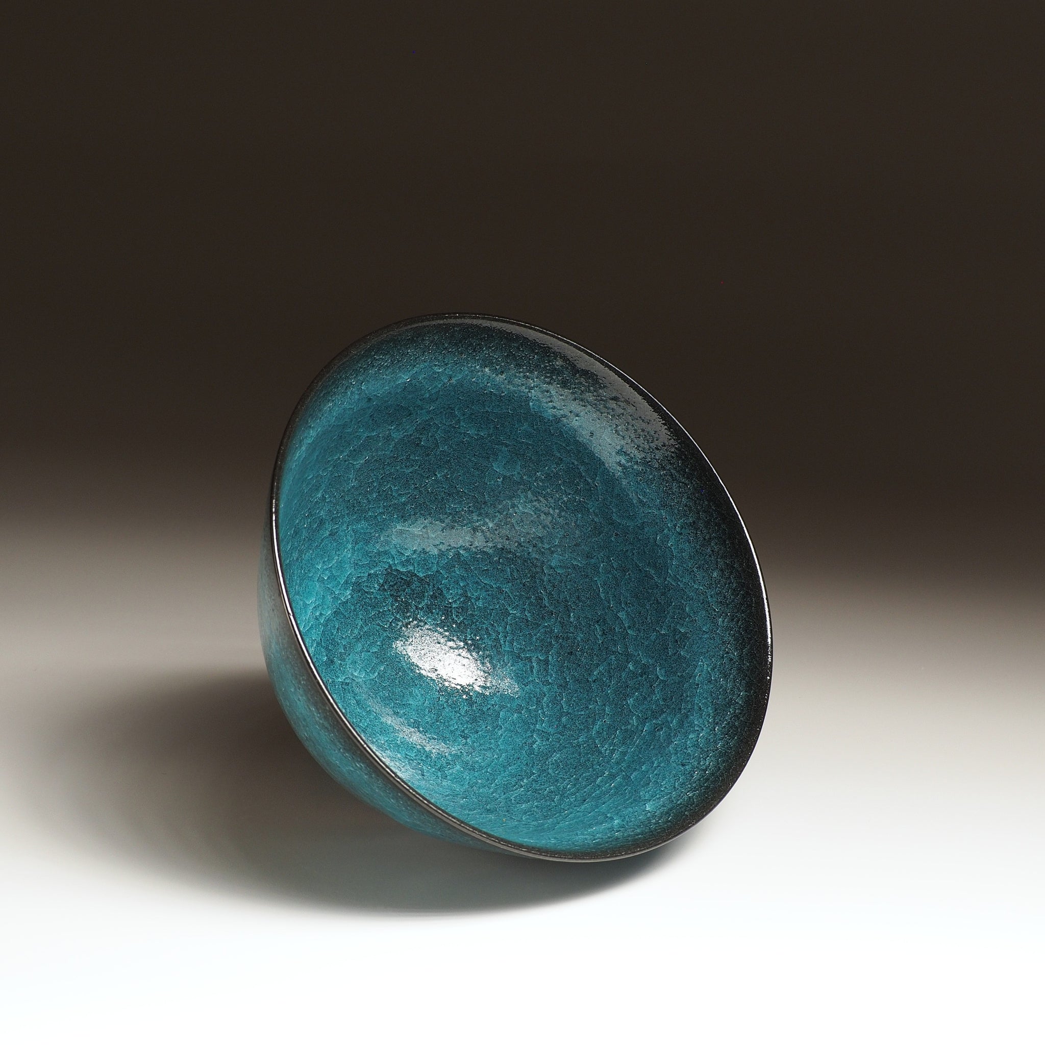 Japanese Emerald green ramen bowl bowl on a dark background. Oblique view