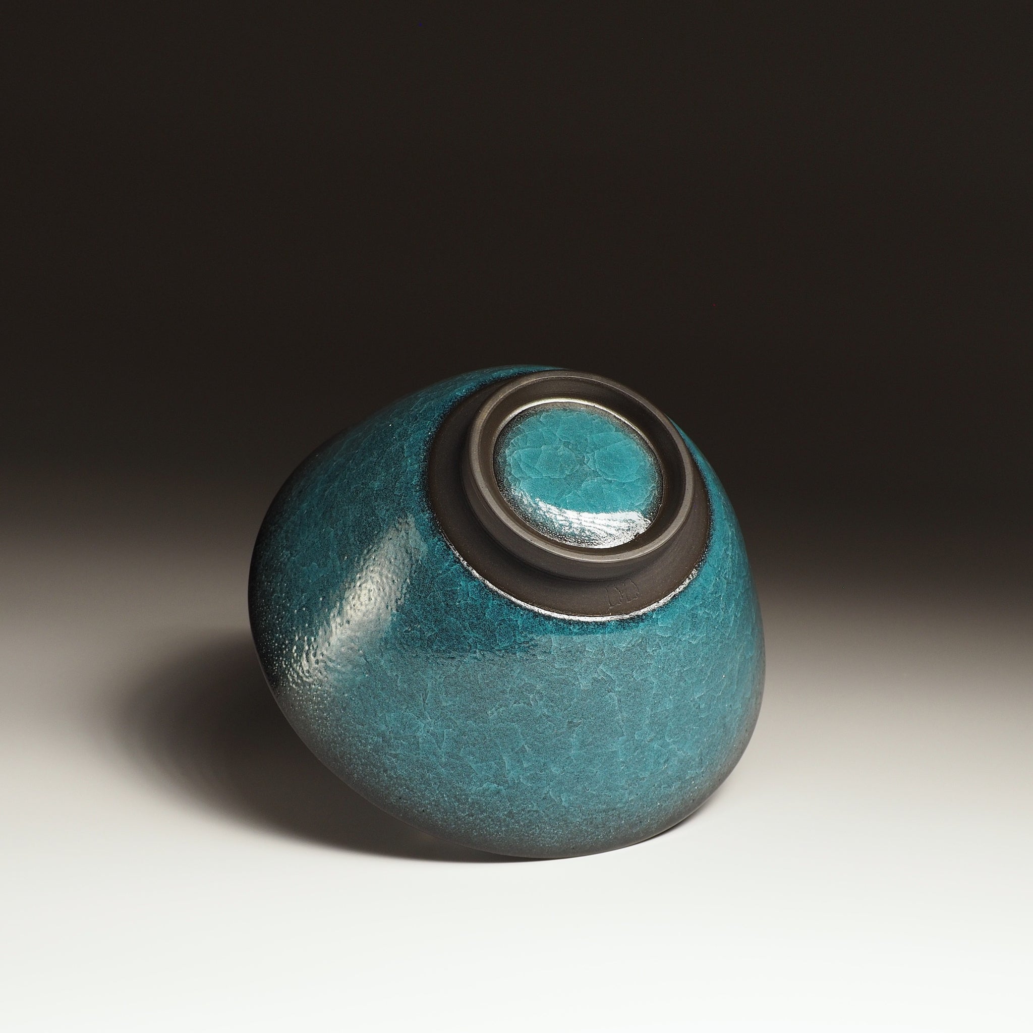 Japanese Emerald green ramen bowl bowl on a dark background. Bottom view