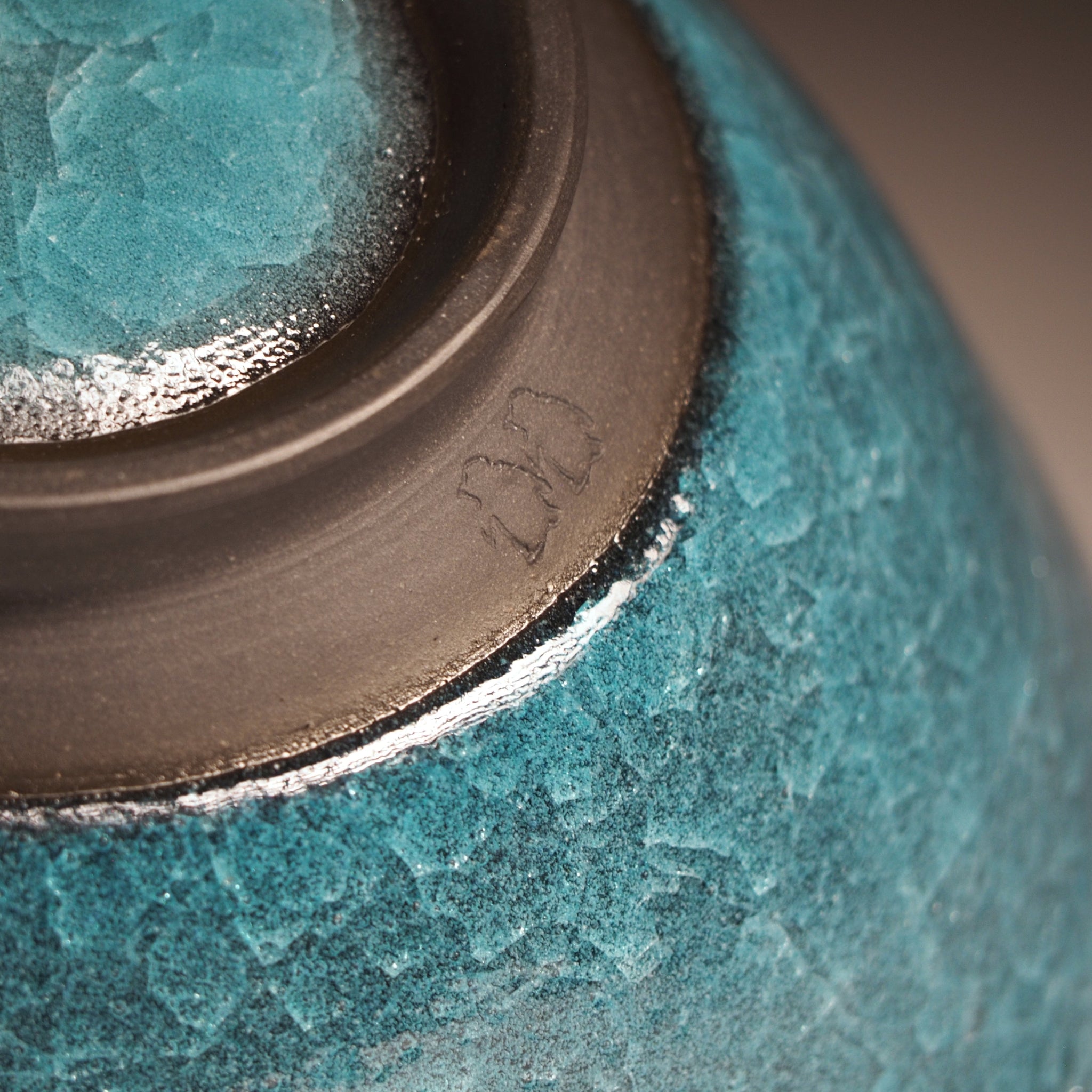 Japanese Emerald green ramen bowl bowl on a dark background. Bottom part detail
