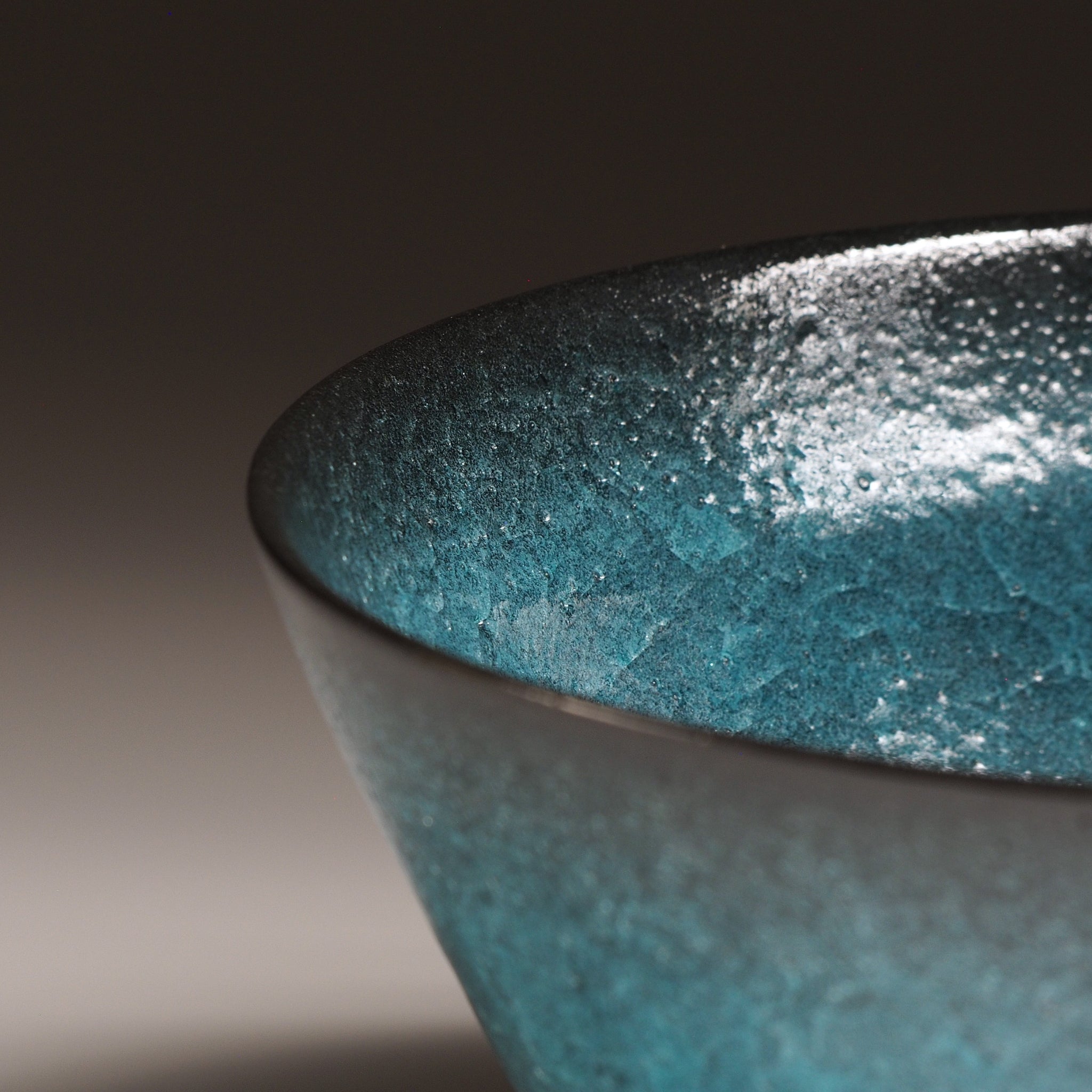 Japanese Emerald green ramen bowl bowl on a dark background. Rim detail view