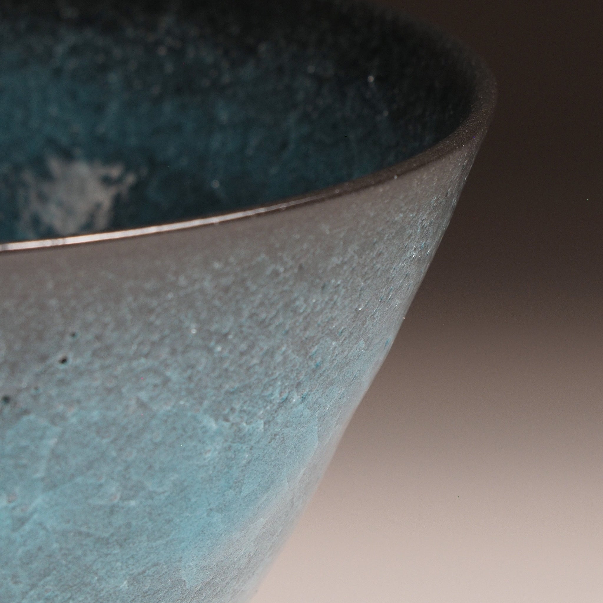 Japanese Emerald green ramen bowl bowl on a dark background. Side detail view