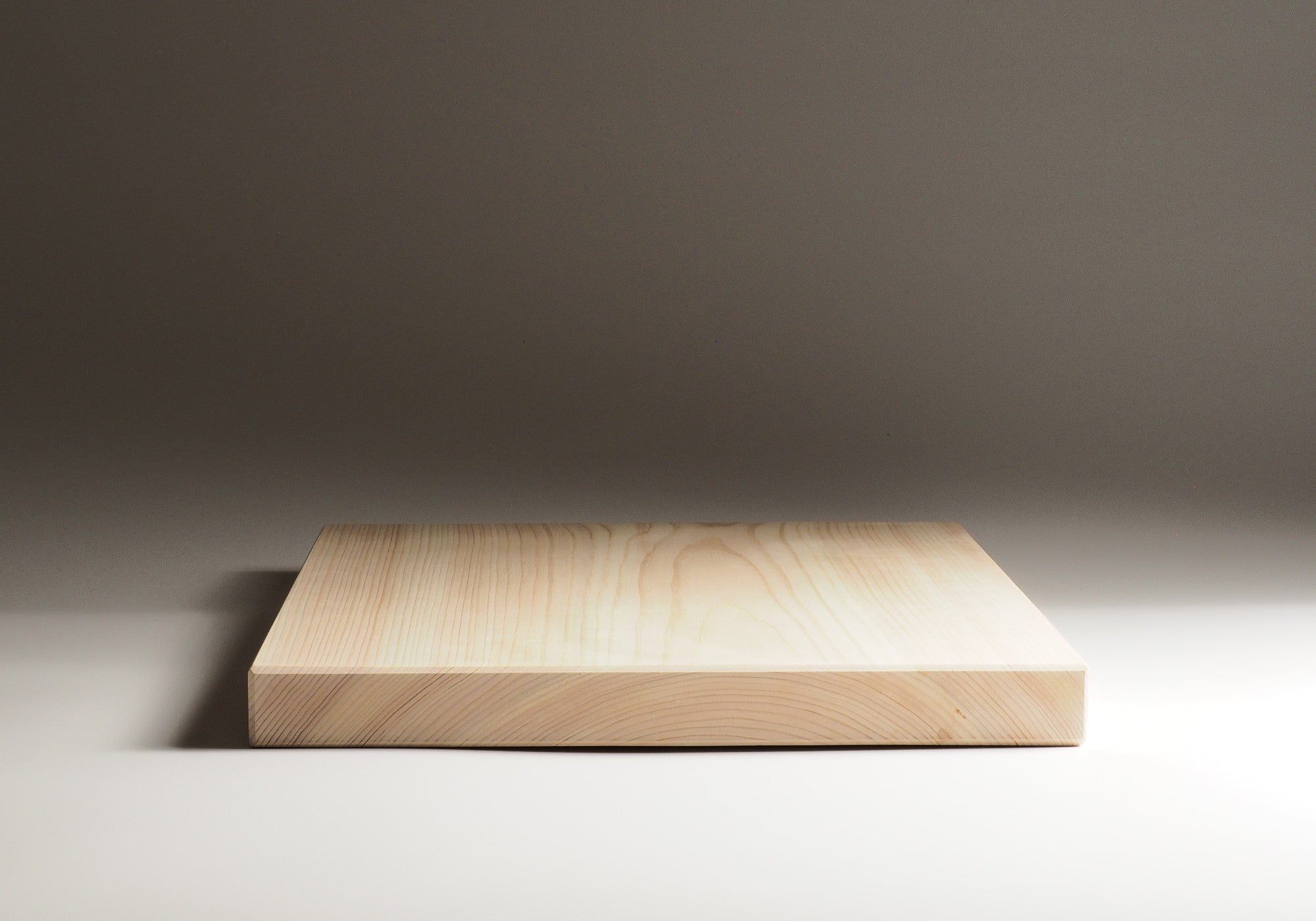 Wooden Japanese cutting board on a gradient background. Tsukushi