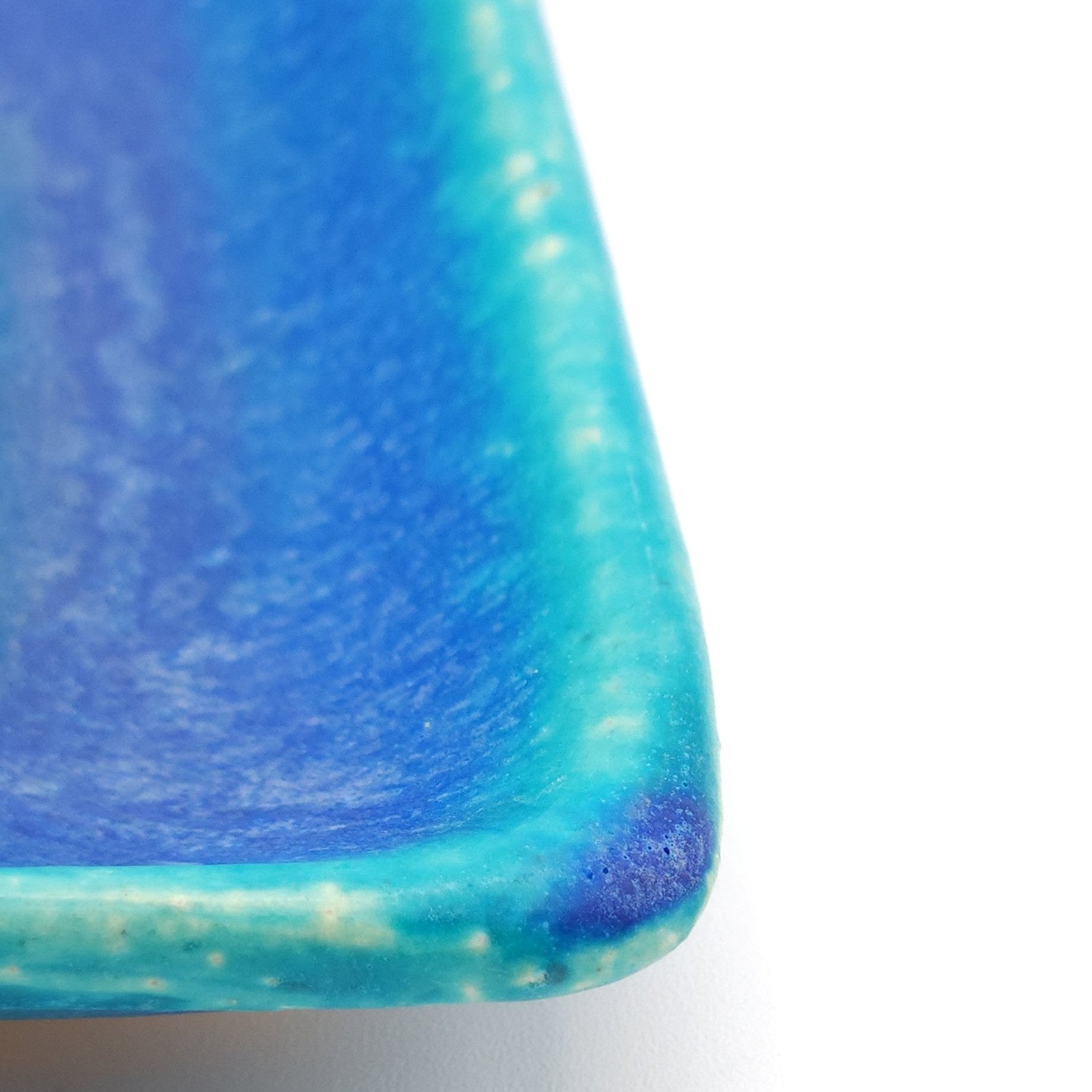 A turquoise Japanese pottery plate measuring 13cm (5.1"). Angle detail