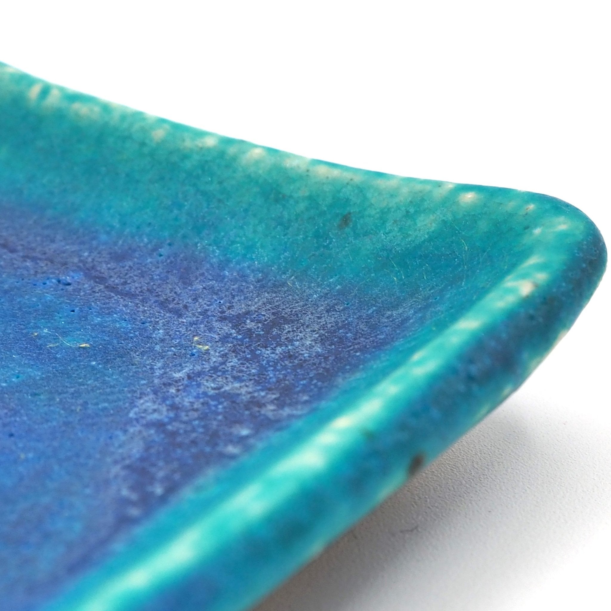 Angle detail of a turquoise Japanese pottery plate measuring 13cm (5.1")