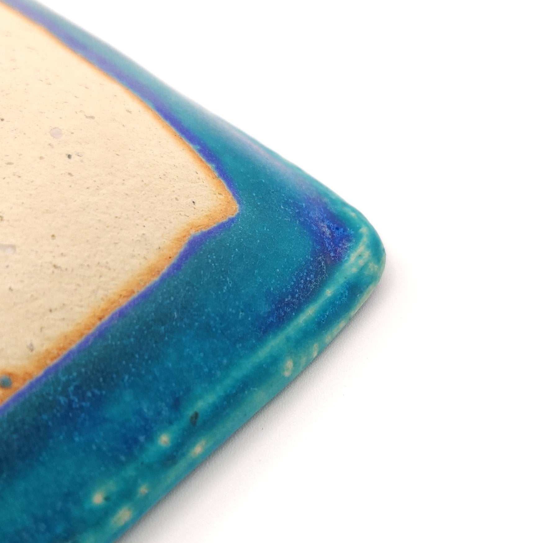 Bottom angle detail of a turquoise Japanese pottery plate measuring 13cm (5.1")