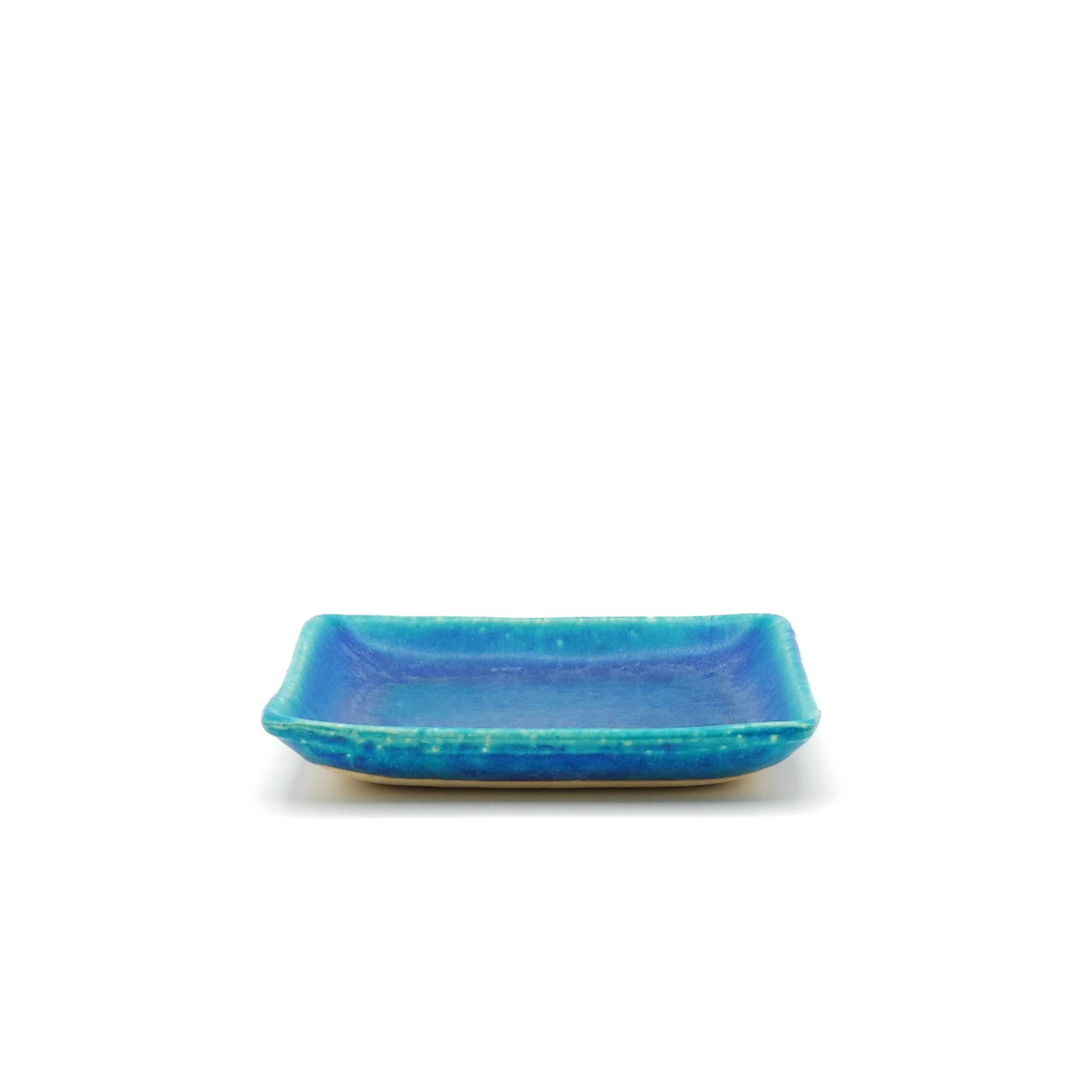 Flont low view of a turquoise Japanese pottery plate measuring 13cm (5.1")