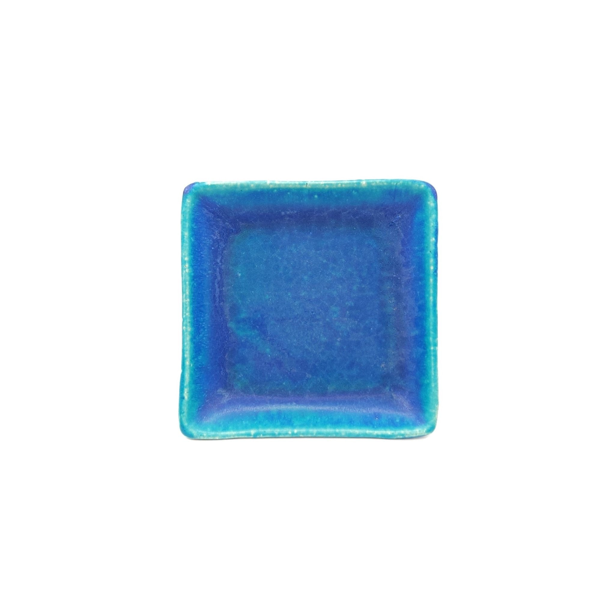 Top view of a turquoise Japanese pottery plate measuring 13cm (5.1")