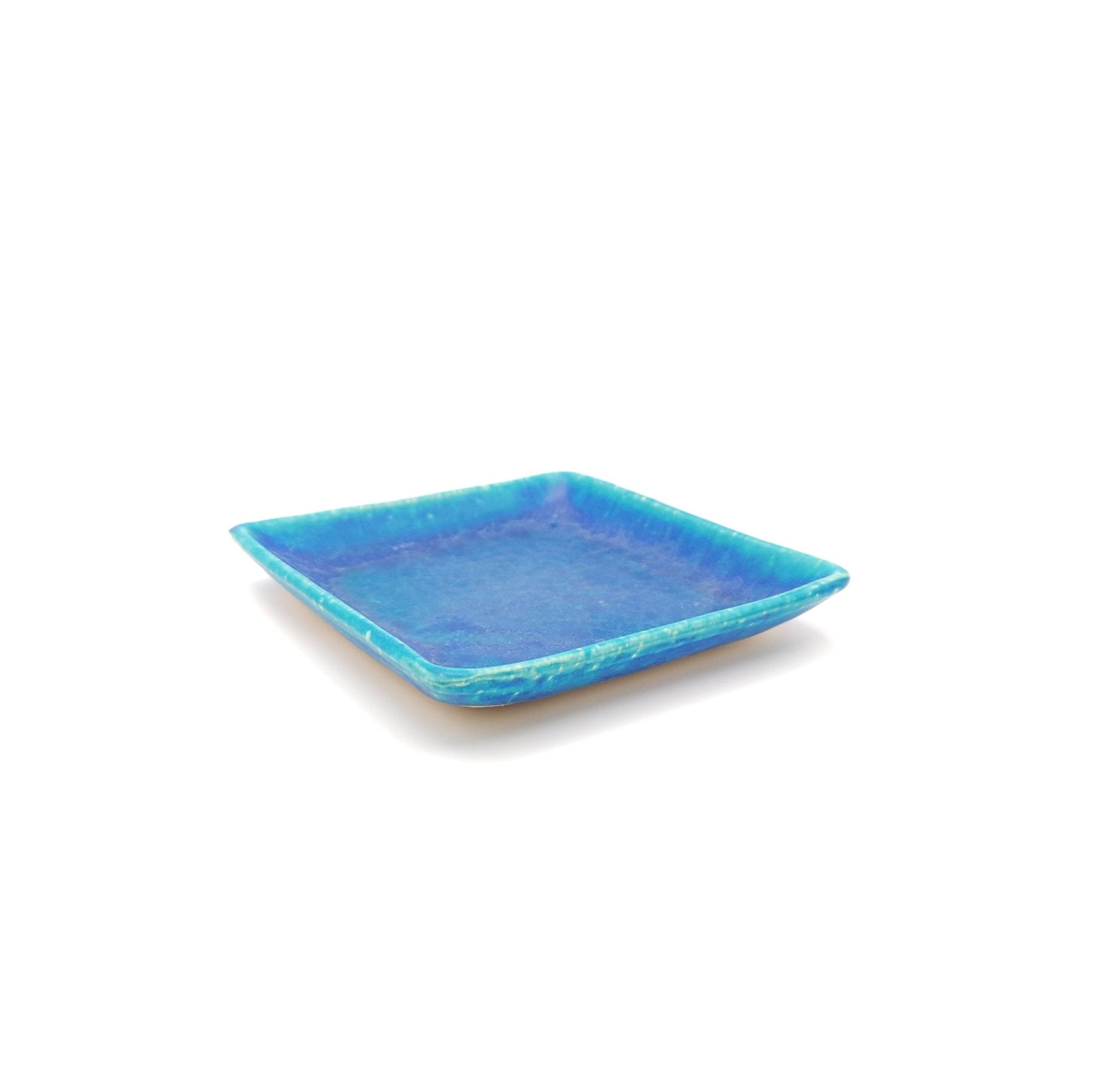 Top side view of a turquoise Japanese pottery plate measuring 13cm (5.1")