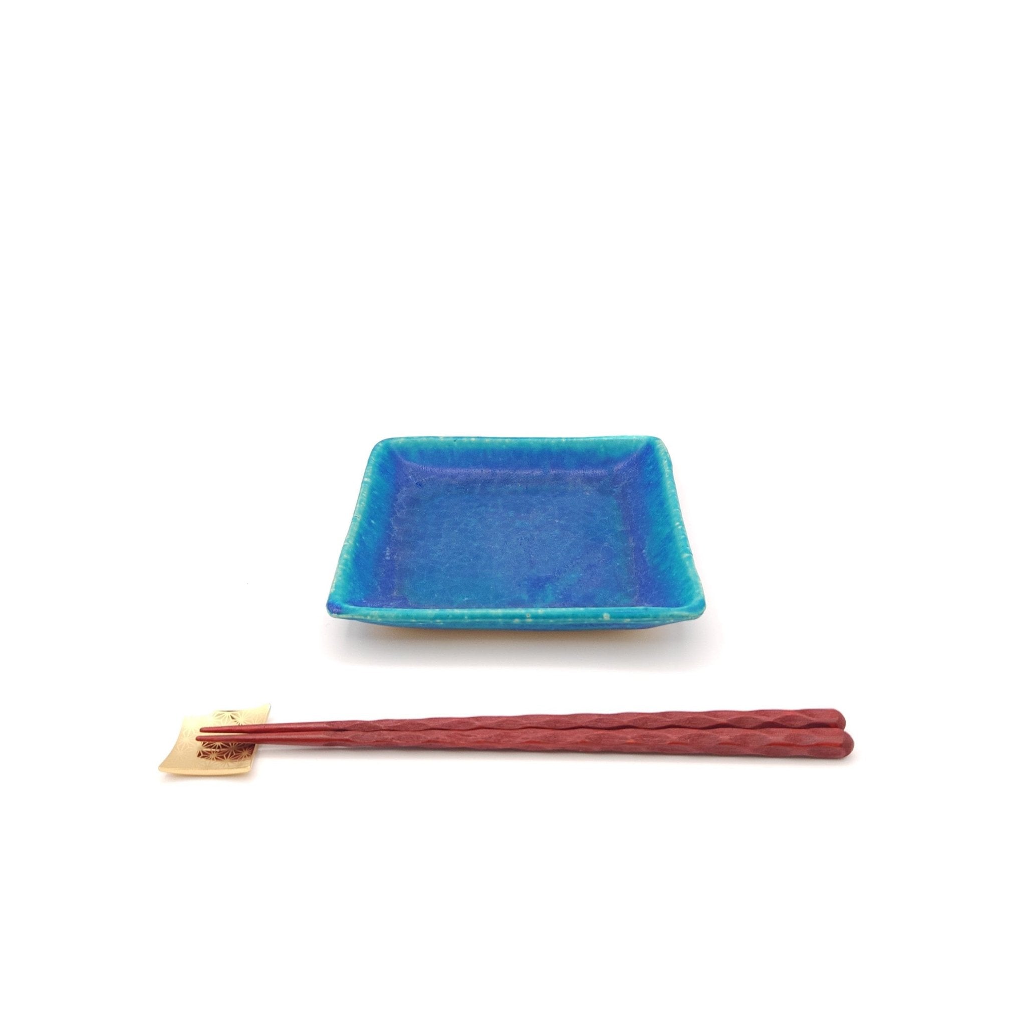A turquoise Japanese pottery plate measuring 13cm (5.1") with chopsticks