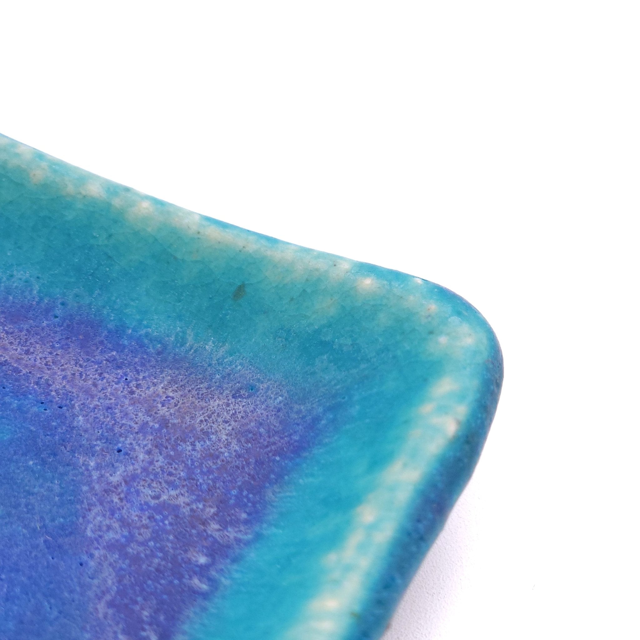 Angle detail of a turquoise Japanese pottery plate measuring 7.5cm (7.9")