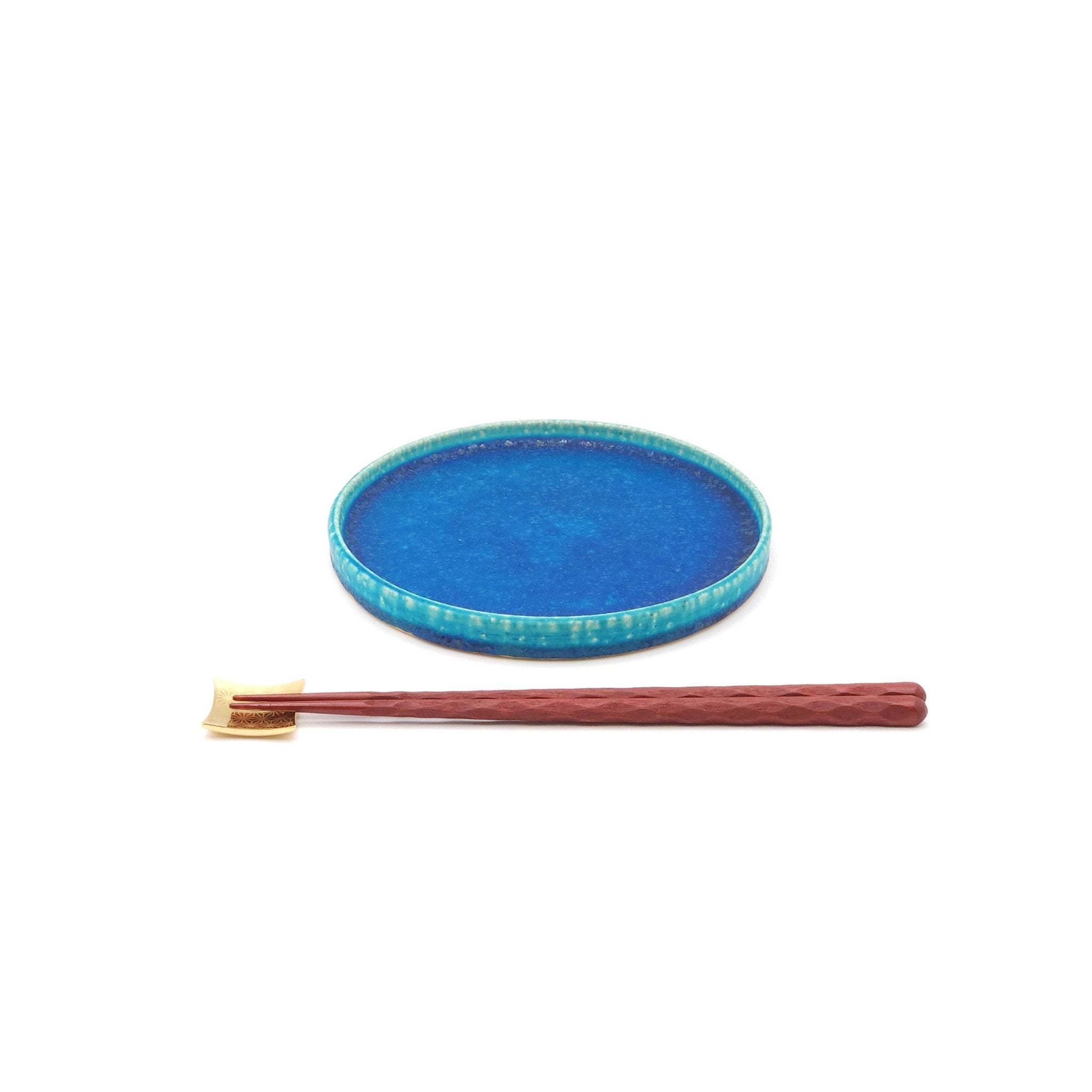 Top front view of a turquoise Japanese pottery round Plate 16cm (9.4") with chopsticks