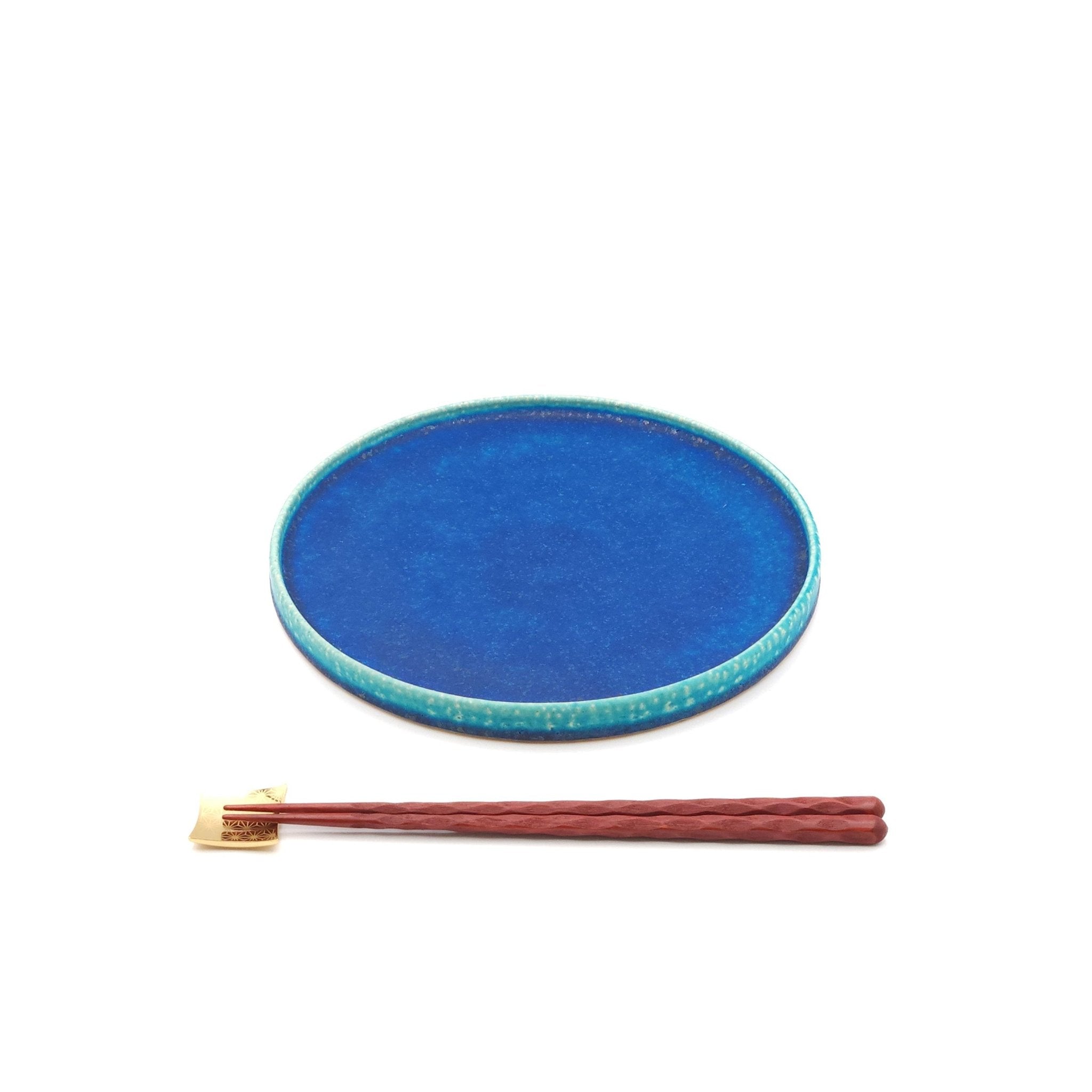 Top front view of a turquoise Japanese pottery round Plate 21cm (8.3") with chopsticks.