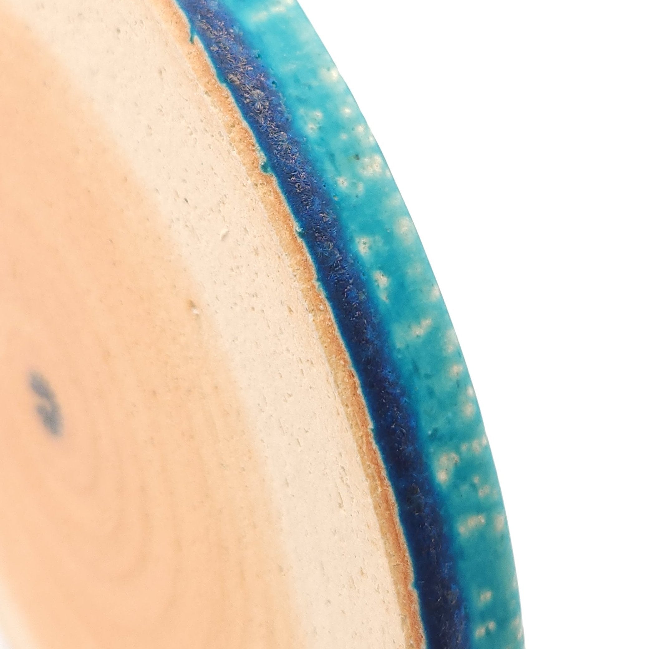 Close up view of the edge of a turquoise Japanese pottery round Plate 21cm (8.3")