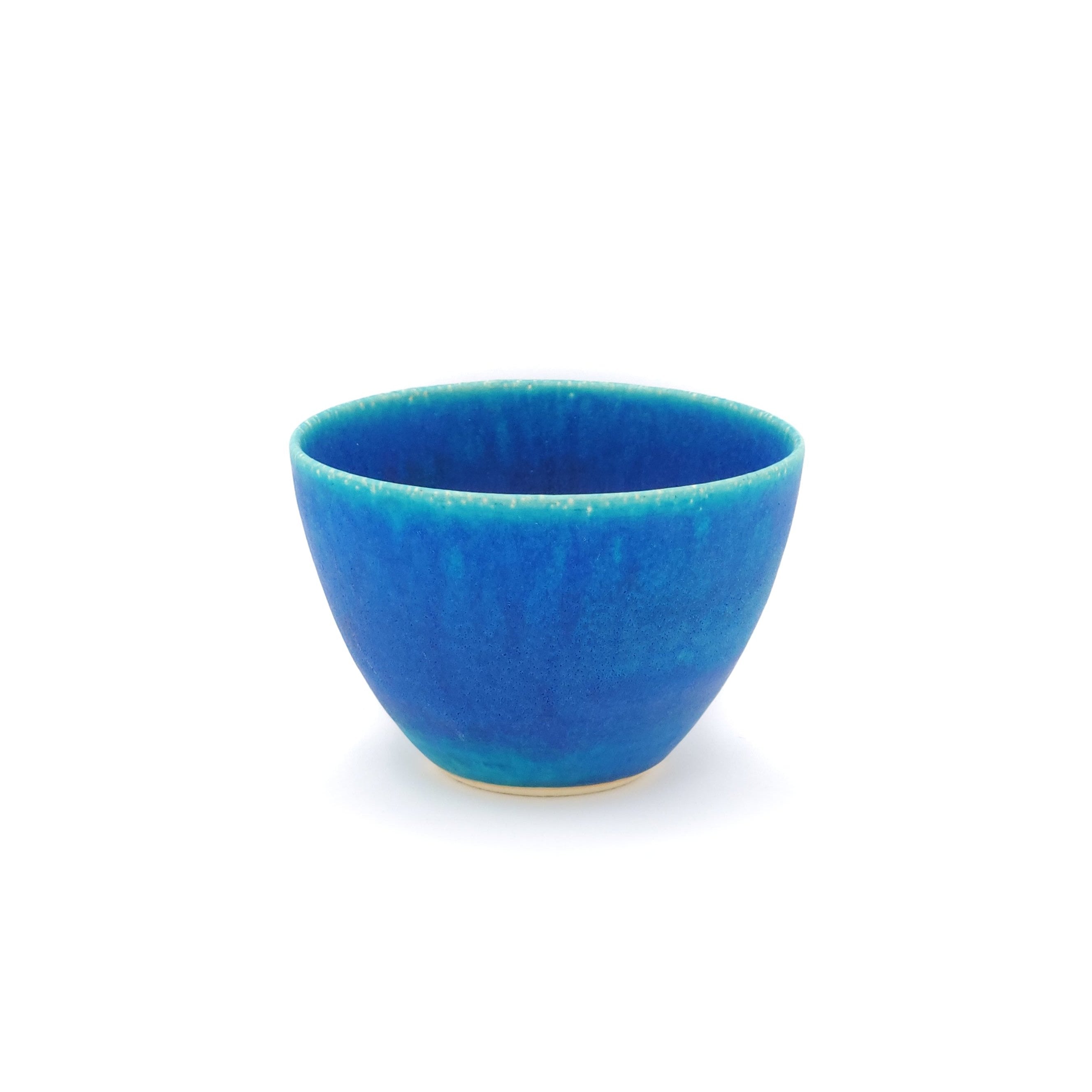 Front view of a turquoise Japanese pottery salad bowl.