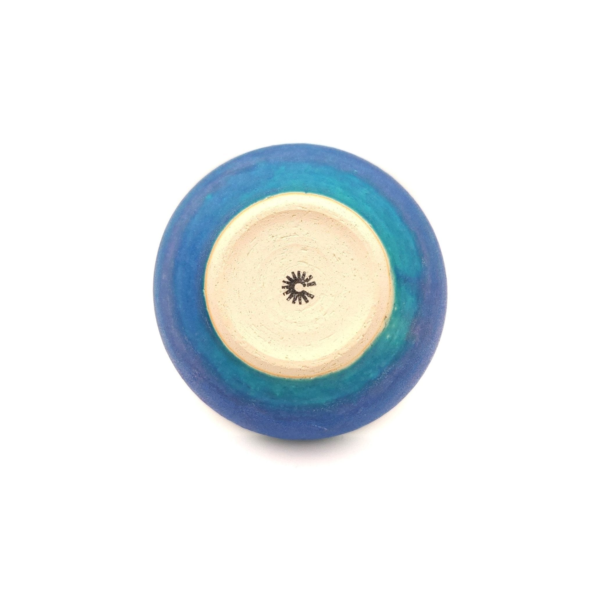 Bottom view of a turquoise Japanese pottery salad bowl