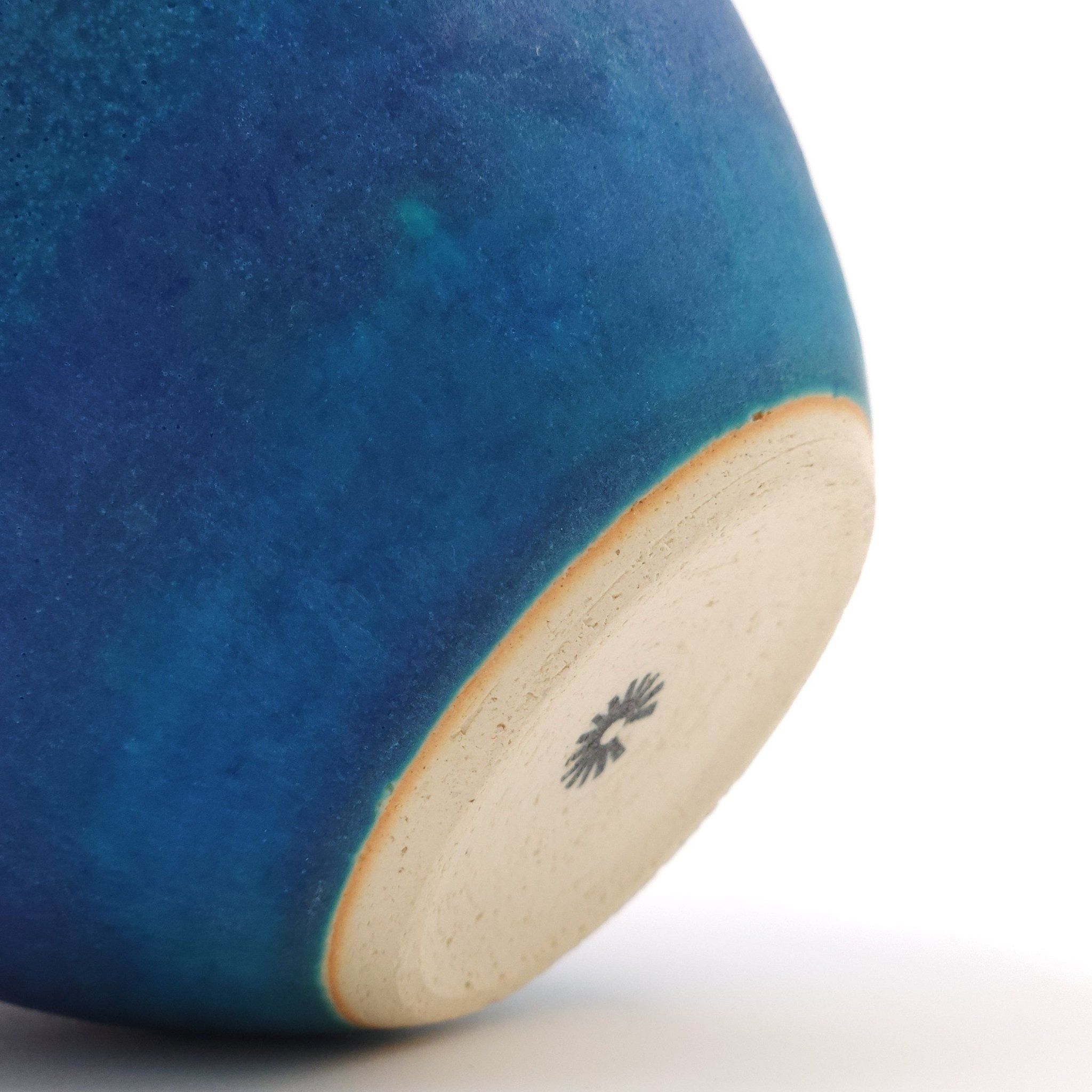 Bottom detail of a turquoise Japanese pottery salad bowl