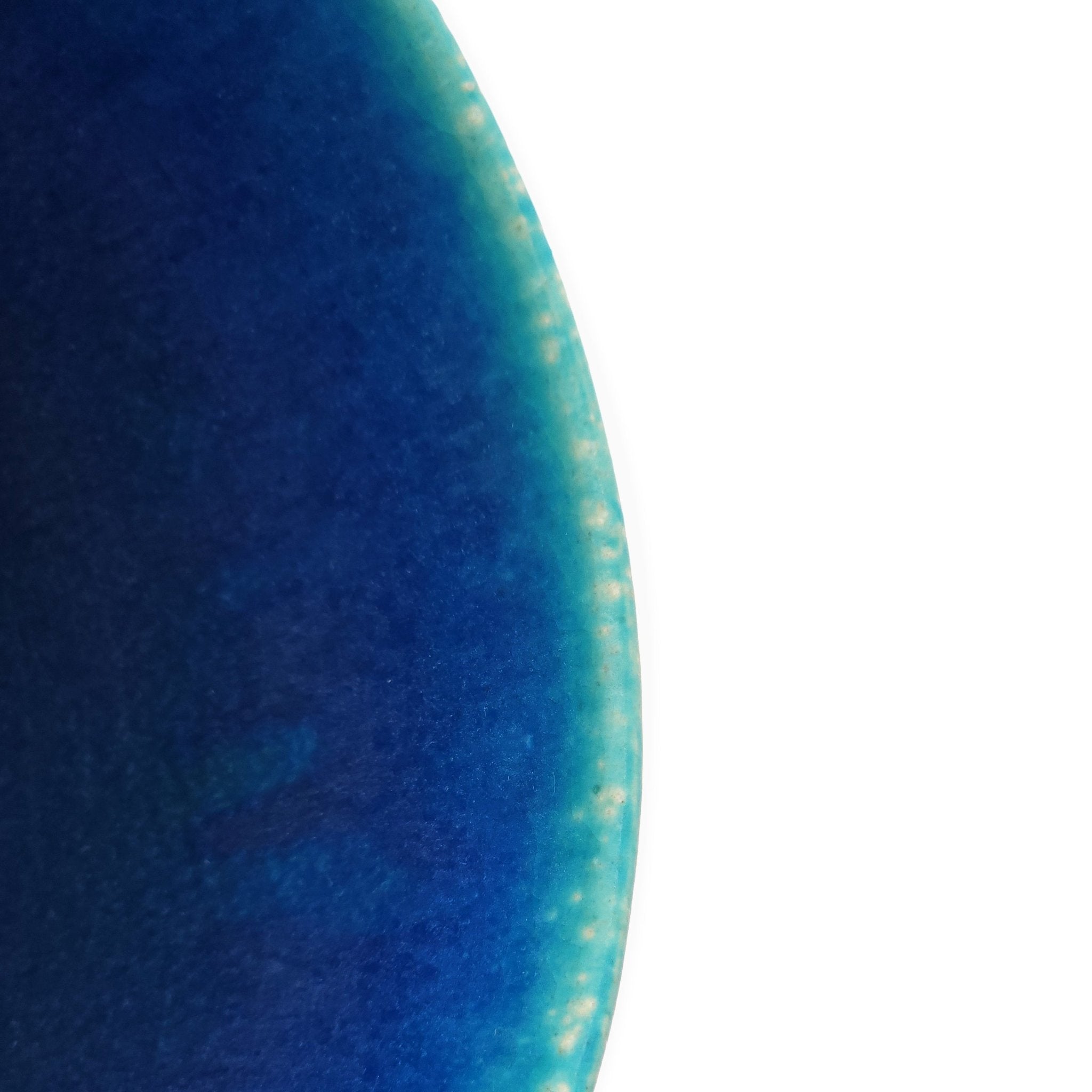 Side detail of a turquoise Japanese pottery salad bowl