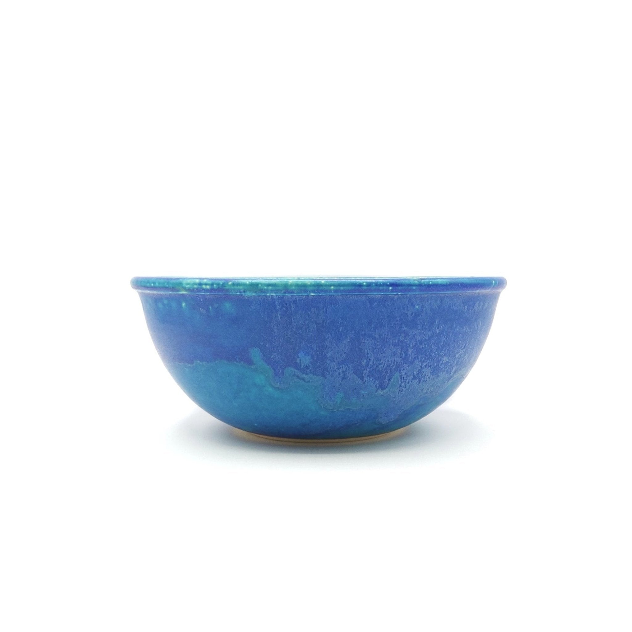 Side view of a turquoise Japanese pottery serving bowl