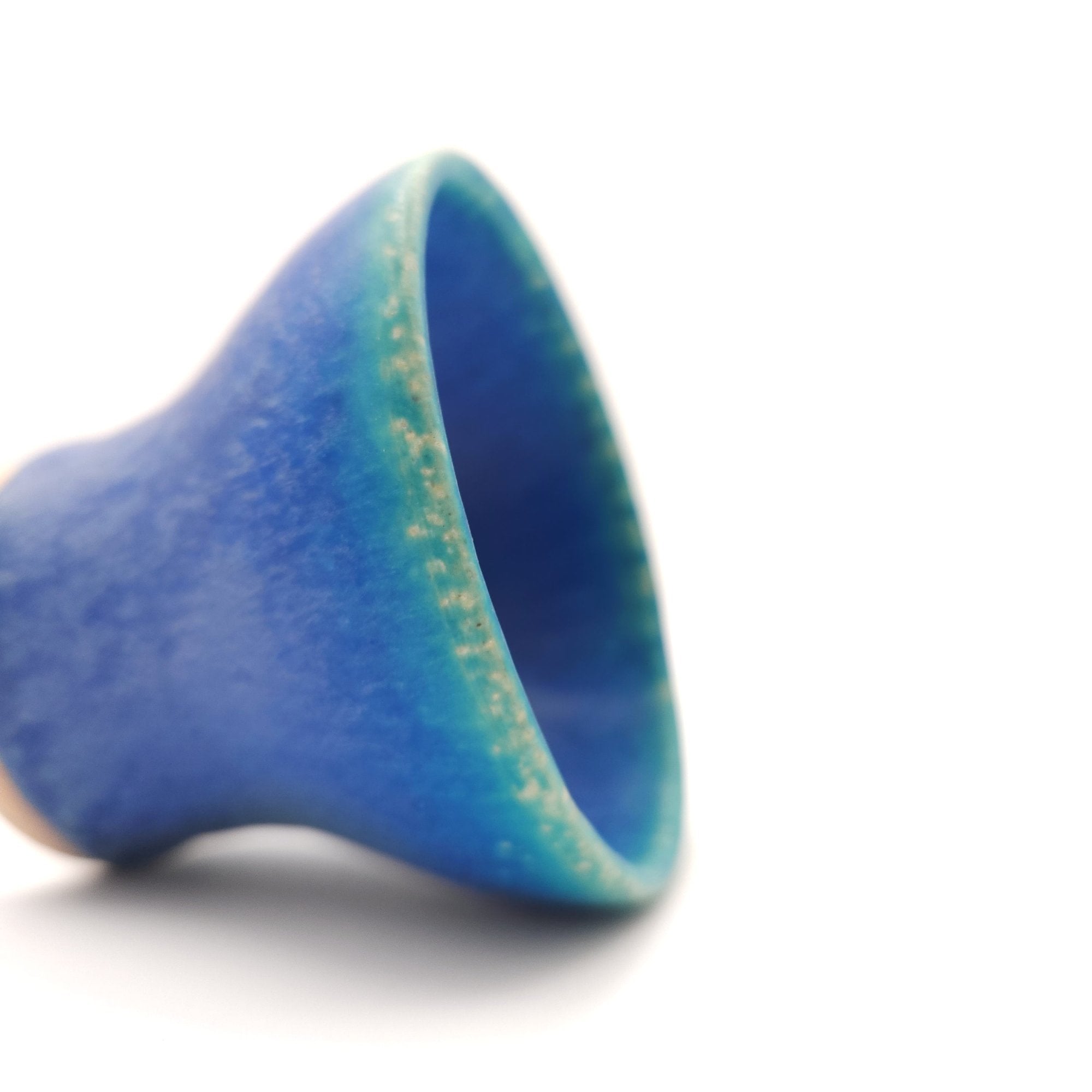 Side detail of a turquoise Japanese pottery small cup