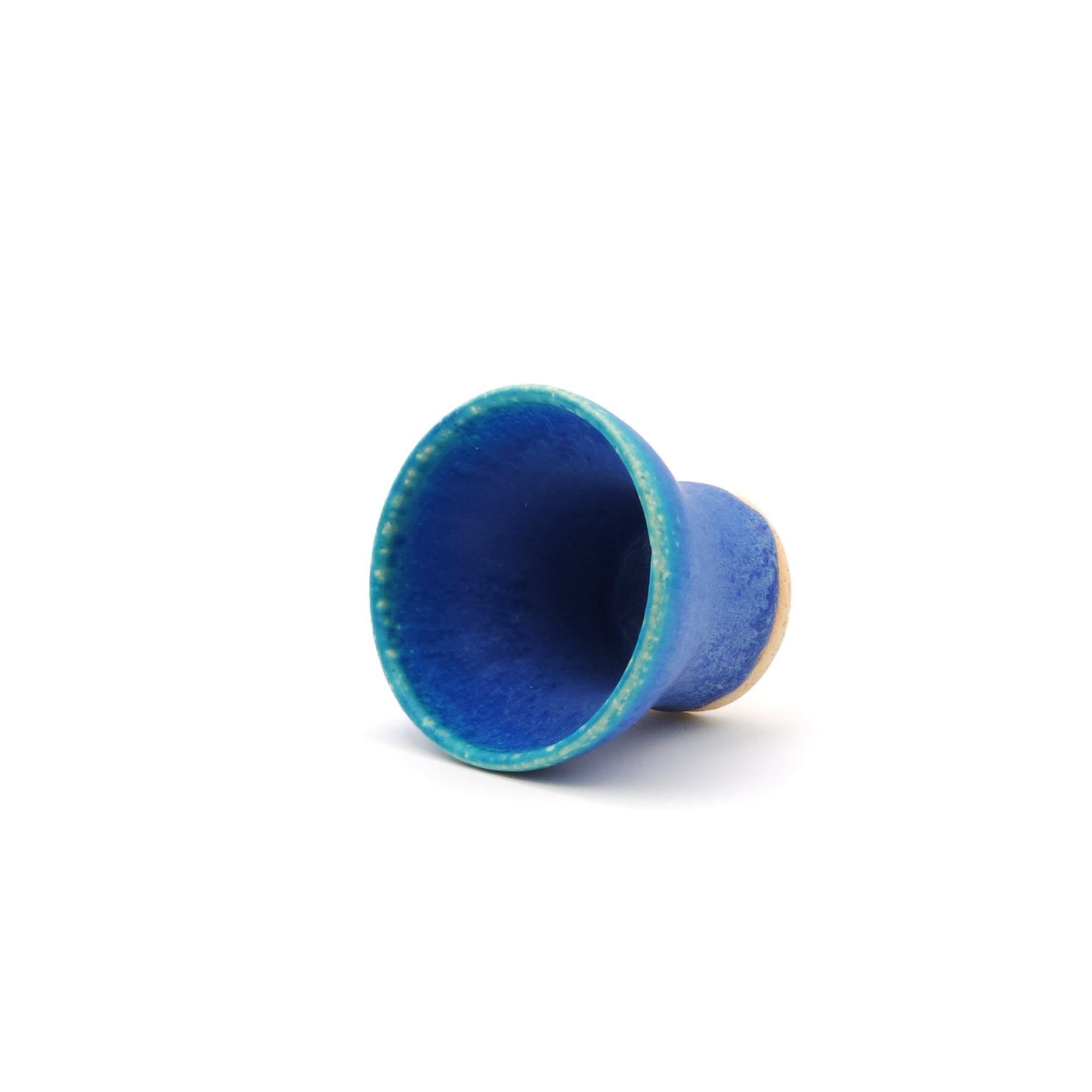 View of a turquoise Japanese pottery small cup on one side