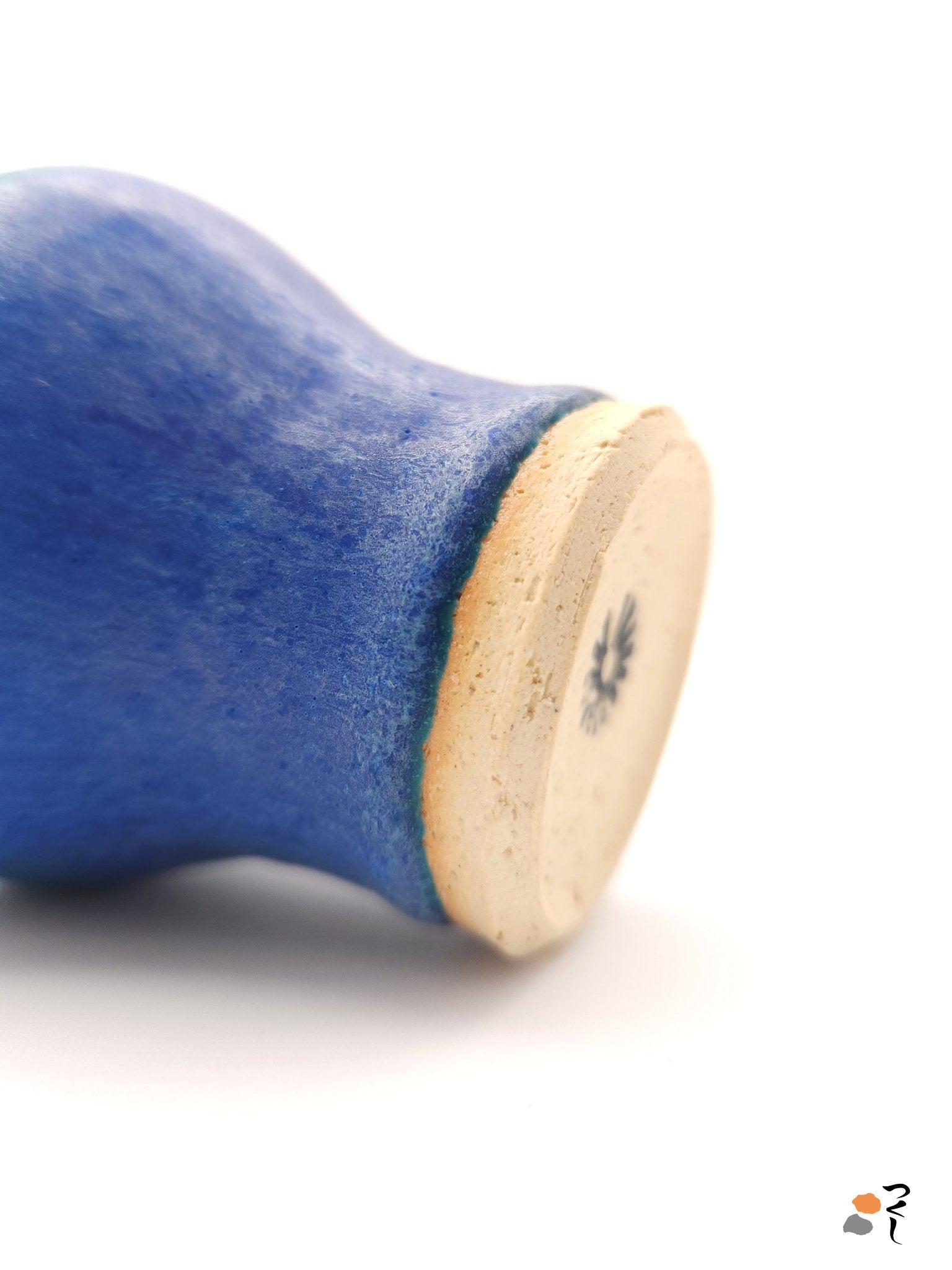 Bottom side detail view of a turquoise Japanese pottery small cup