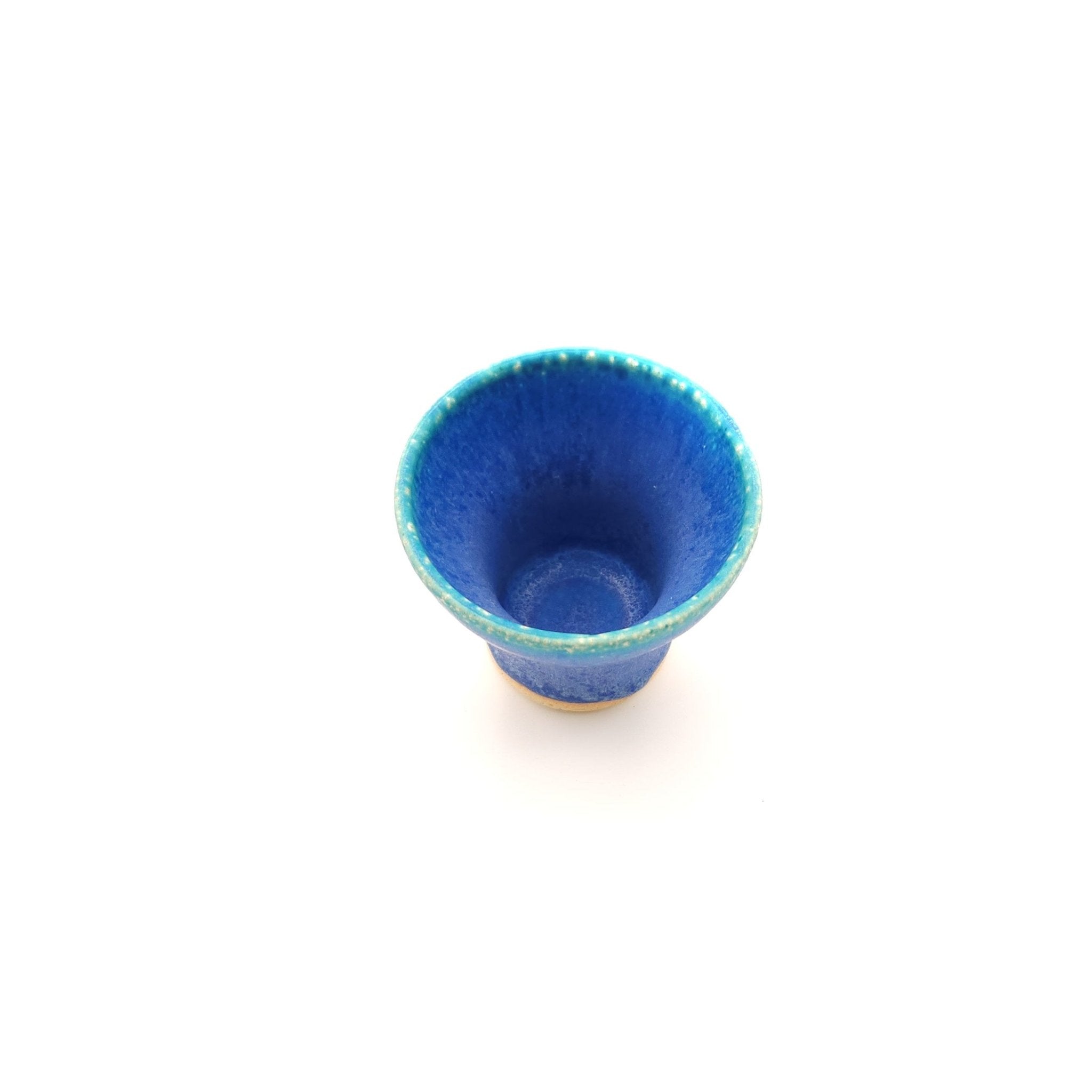 Top side view of a turquoise Japanese pottery small cup