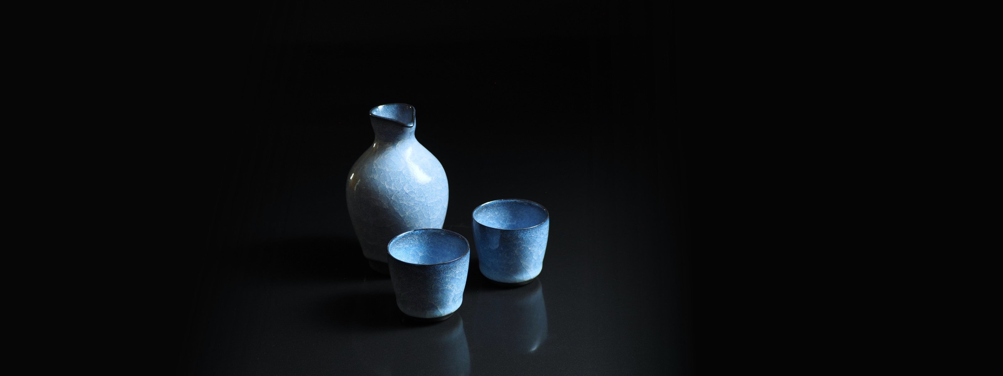 Pottery Sake set on a dark background