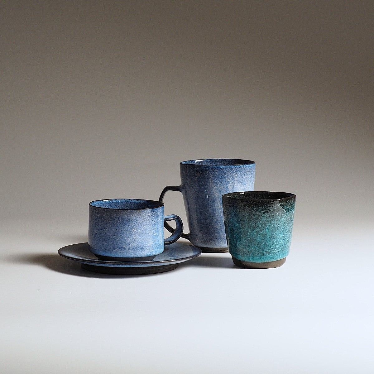 Japanese handcrafted crazing ceramic coffee cup set and Mug cups beige background, Tsukushi