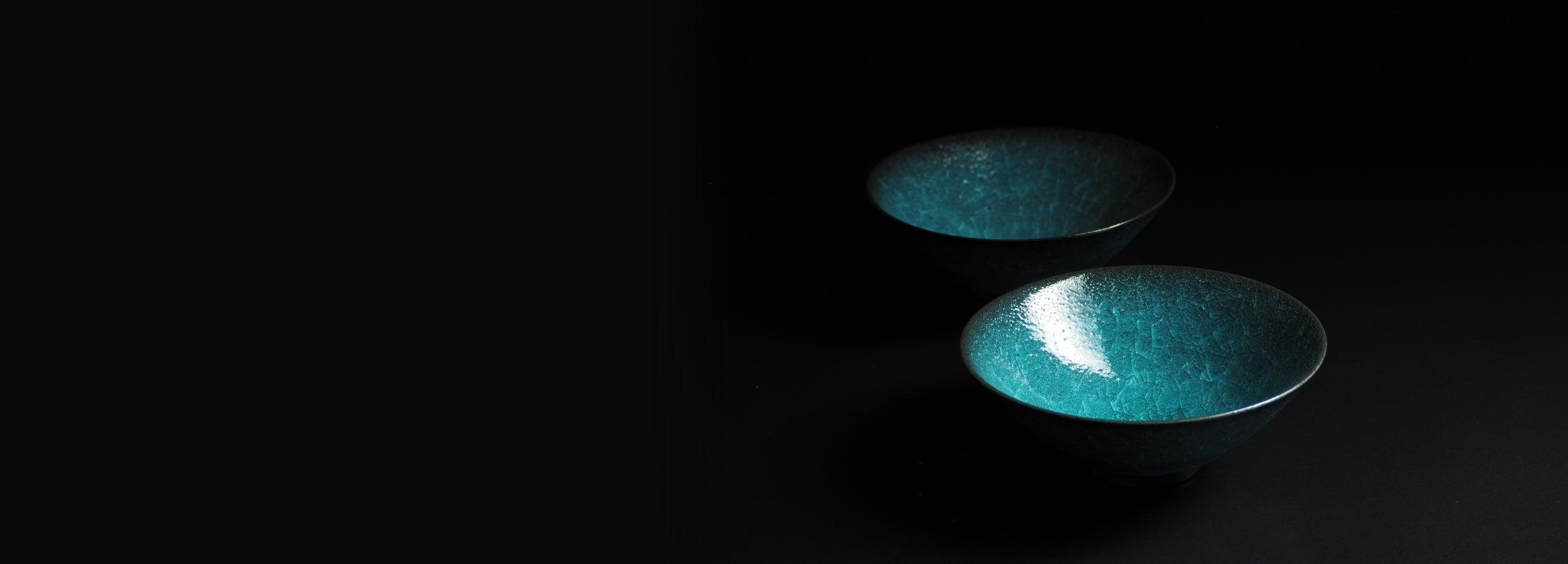 Japanese handcrafted crazing ceramicbowl black background, Tsukushi