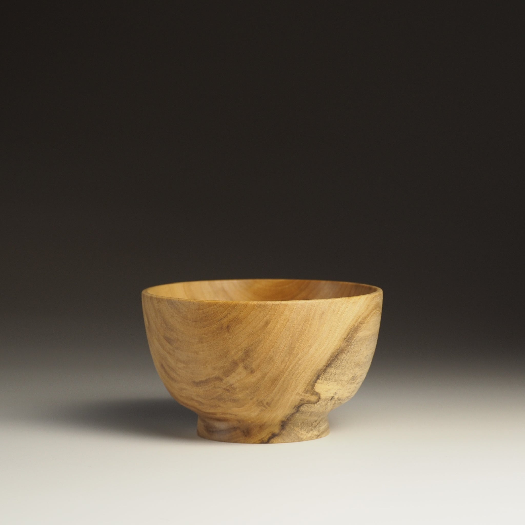 A side view of Japanese Wooden Bowl on a gradient background. Tsukushi