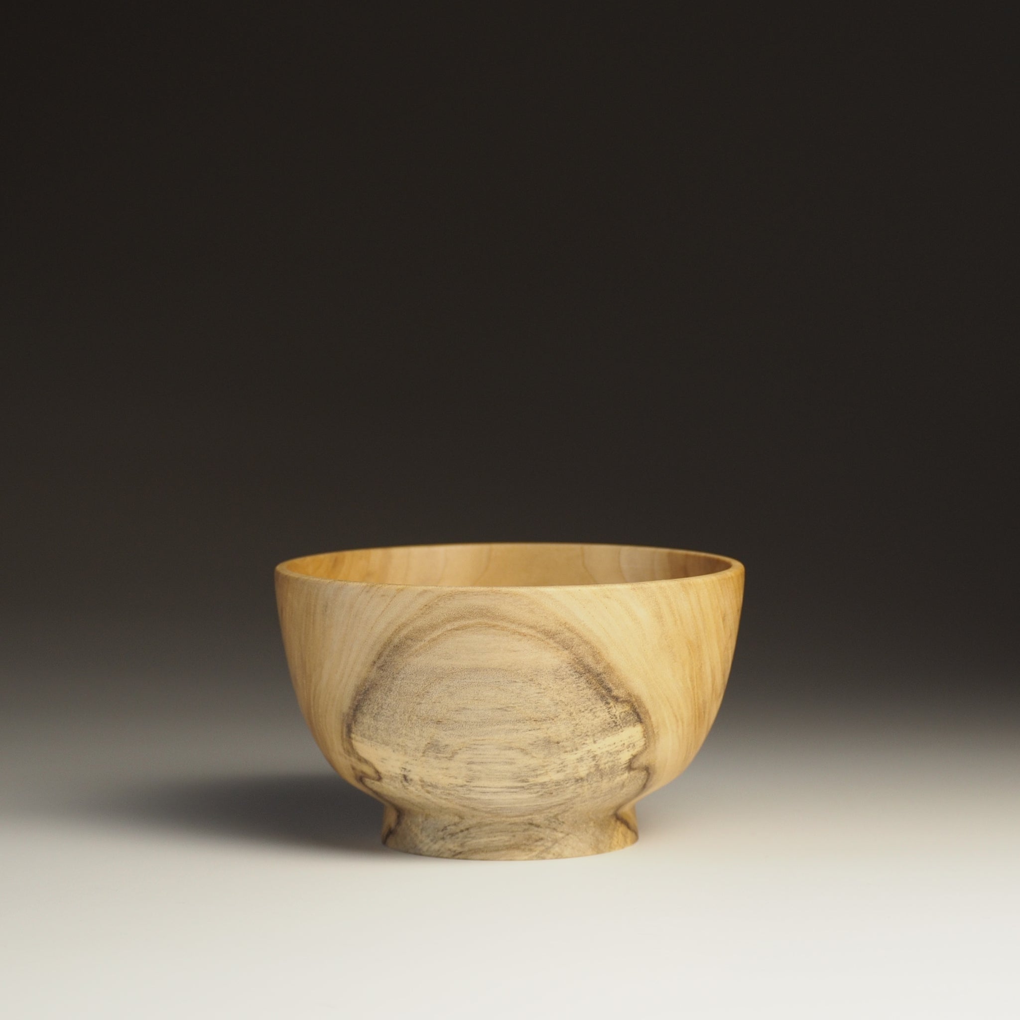 A Japanese Wooden Bowl black background. Tsukushi